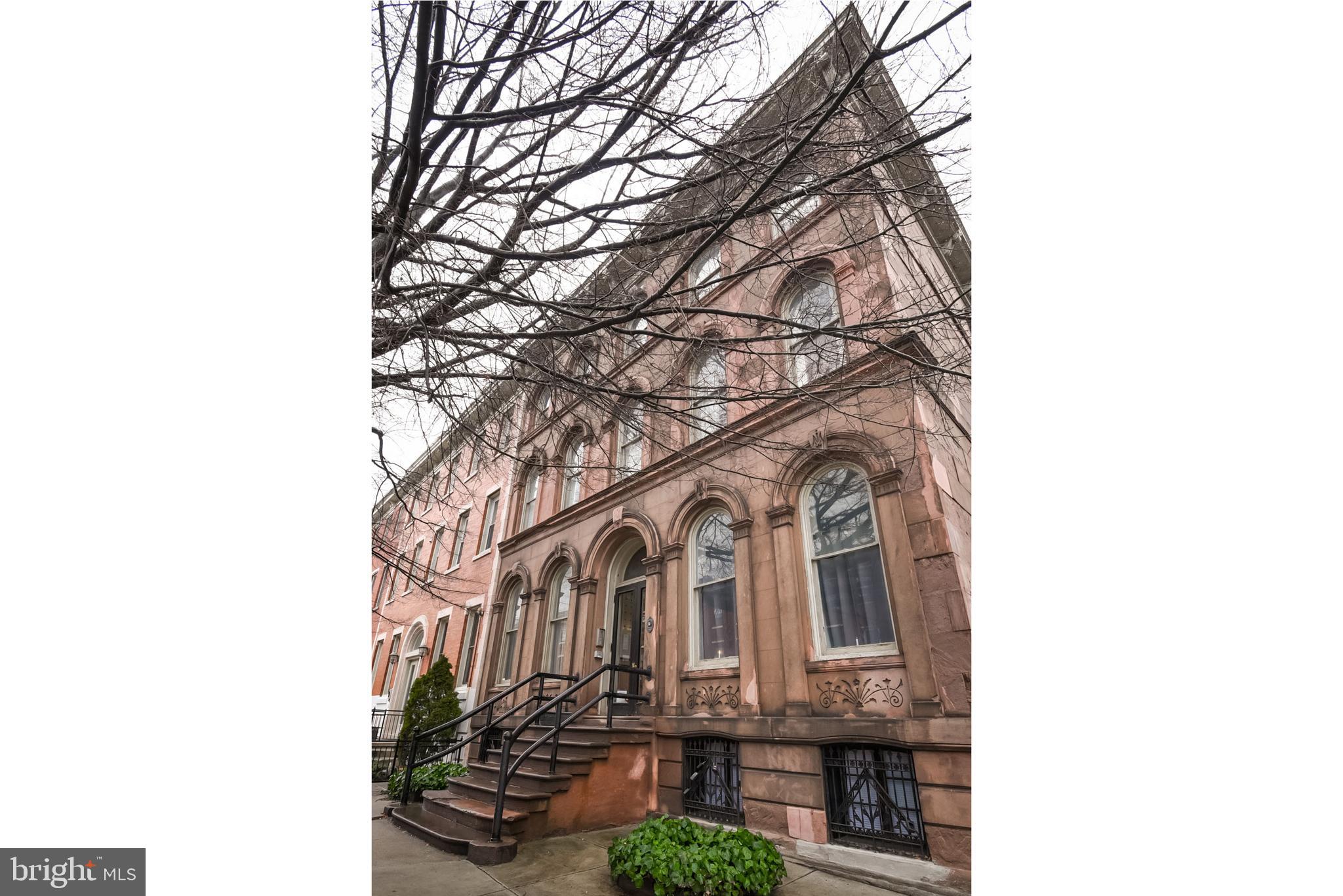 Exquisite old world charm awaits you in this dramatic bi-level one bed/ two bath condo in the heart of Fairmount! Nestled on a gorgeous tree lined block in a historic brownstone, just steps from all that Fairmount has to offer. The light flows throughout the sleek and modern main level which is complimented by a neutral pallet of fresh paint.You ll be blown away by the soaring 14 foot ceilings, huge windows, original detailed hand carved woodwork, marble fireplace and newly refinished hardwood floors. The eat-in kitchen features wood cabinets, granite counters, Viking stove and a charming breakfast nook with ornate windows that leaves little to be desired! A full bath and walk-in storage closet with custom outfittings complete this level. The rear features access the outdoor patio through your oversized back door with decorative glass storm door. Head downstairs to the comfortable and quiet bedroom with new carpeting and two spacious closets (and custom California closet shelving for maximum space). There is a second full bathroom and a washer/dryer in a separate closet on this floor. A private storage unit in the shared basement provides additional space. Forced Air Heat and A/C throughout. Security system, recessed lighting with dimming switches and high end touches like antique solid wood closet and bathroom doors give this home a unique blend of modern living with historic refinement. Blocks from Fairmount Ave restaurants and nightlife, a short distance to Kelly Drive, the Art and Rodan Museums, Rittenhouse Square, Wholefoods, Pizzeria Vetri and City Hall. A community garden and recreational park are within the block as well as a new dog park. Easy access to 676. Public parking lot directly behind the house for use outside of school hours. This is the one! Seller will review all offers on Tuesday, February 18th