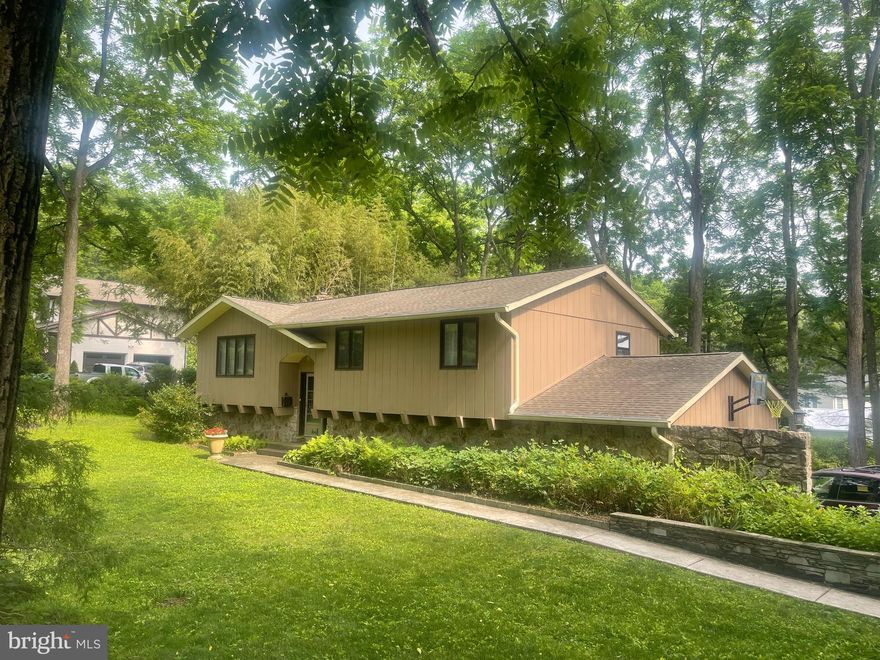 Welcome home to this countryside bi-level in the heart of the Southern
Lehigh School District. Set on a generous, tree-lined lot with private off-
street parking and a large 2-vehicle attached garage, this home offers over
2040 finished square feet of living space including 3 bedrooms, 1 full
bathroom, and a half bath in the partially finished basement. The open
concept living space features an eat-in kitchen with ample counter space
and an island, wood floors, and sliding glass doors leading to a portion of
the deck that runs along the length of the house, which is one of the
home’s standout features. The main floor primary bedroom includes
sliding doors that open to a 260 square feet deck, creating a private
sanctuary with beautiful views that flows into the spacious backyard. The
open grounds invite gardening, recreation, or simply enjoying nature. The
partially-finished basement is loaded with potential — complete with a
family room with stone fireplace, half bath, laundry area, and ample
storage. Central AC and electric heat make this home cozy in all seasons.
Convenient to the Saucon Valley Rail Trail, all major roadways, parks,
shops, and restaurants, this home is also close to outdoor adventures,
including cycling, hiking, horseback riding, and fishing at nearby lakes.
With a perfect balance of country charm and modern convenience, this
inviting retreat is ideal for full-time living.