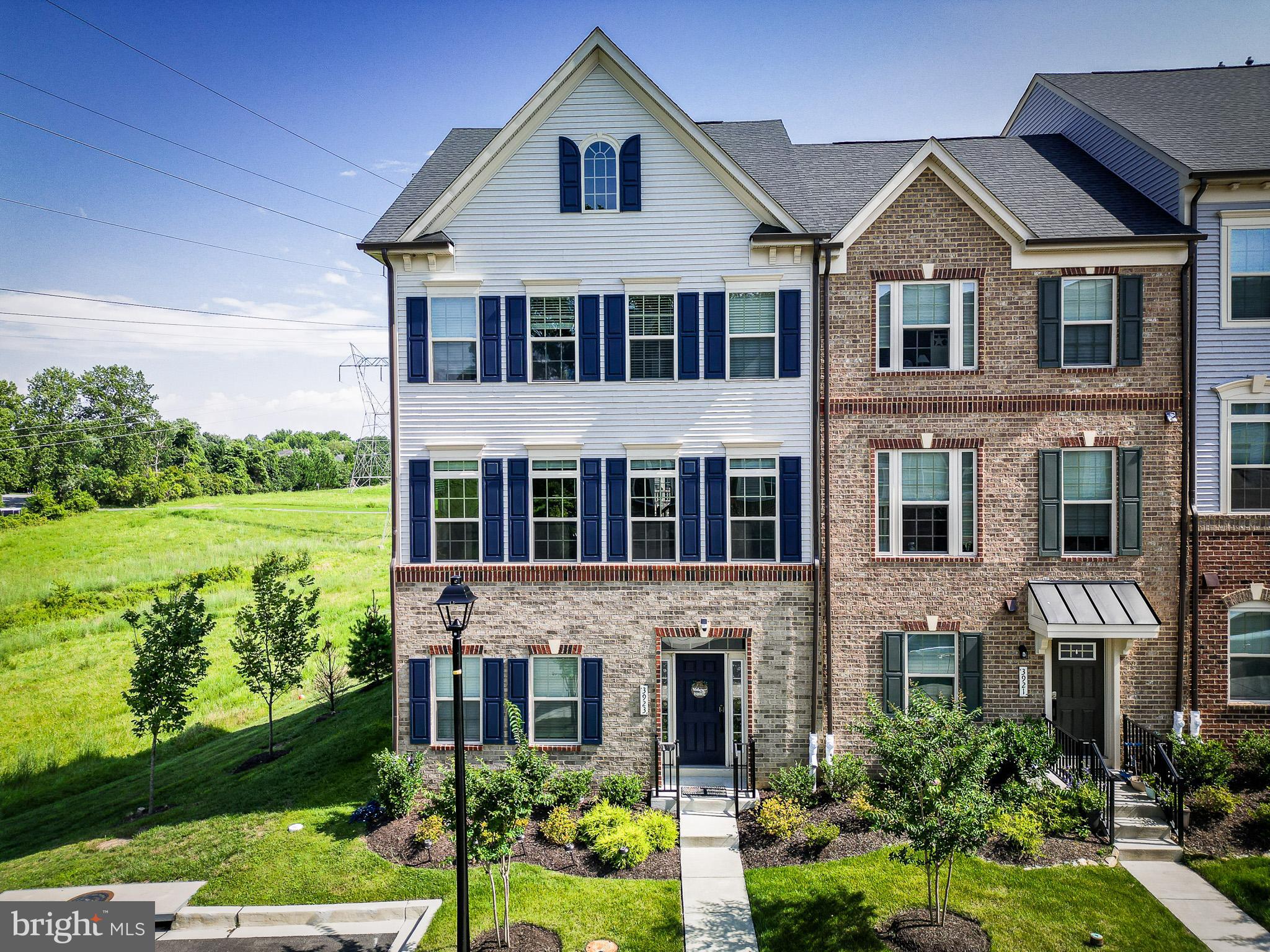 Discover exceptional elegance and modern convenience in this rare 4-bedroom, 4.5-bath luxury end-unit townhome—one of only six in the community featuring a fully finished top level. As a premier corner unit, every floor is filled with natural light from three additional windows per level, creating an airy, sun-filled atmosphere throughout. Inside, a thoughtfully designed layout showcases high-end upgrades at every turn. The gourmet chef’s kitchen impresses with stainless steel appliances, an expansive entertainment-ready island, two pantries, soft-close cabinetry, and touch/sensor faucets. A formal dining room with a private powder room flows seamlessly from the kitchen, while the spacious living room opens to the first of two private balconies with dual French doors—perfect for indoor-outdoor living. The primary suite is a true retreat, complete with two walk-in closets and a spa-inspired bath. Wide 8-inch wide LVP flooring extends across the entire second level, staircases, & third-floor landing, beautifully accented by crisp white LED lights with customizable color options. Every bathroom features quartz countertops and soft-close cabinetry, while the laundry is conveniently located next to the primary suite. The rare top-level suite—unlisted in the public tax record adds an extra 537 sq. ft. of living space, offering a private bedroom with a walk-in closet, a full bath, and a balcony with sweeping community views. The entry level offers a flexible bonus space ideal for a family room, home office, or playroom with a full bath. Two mechanical rooms house dual HVAC systems for year-round comfort, while designated storage areas on every floor provide exceptional organization. The fully finished two-car garage includes sleek epoxy flooring, additional storage, an EV charger hookup, and a WiFi-enabled garage door for effortless, connected access. Ideally situated near the local YMCA, Longwood Shopping Center, and major commuter routes (29, 100, I-70), this home offers easy access to daily conveniences and stress-free travel. Located within the sought-after Centennial High School district, it’s perfect for families seeking top-tier education in one of Howard County’s most prestigious school zones. Blending luxury finishes, smart home features, and a highly desirable Ellicott City location, this home delivers an unparalleled living experience—an opportunity not to be missed.