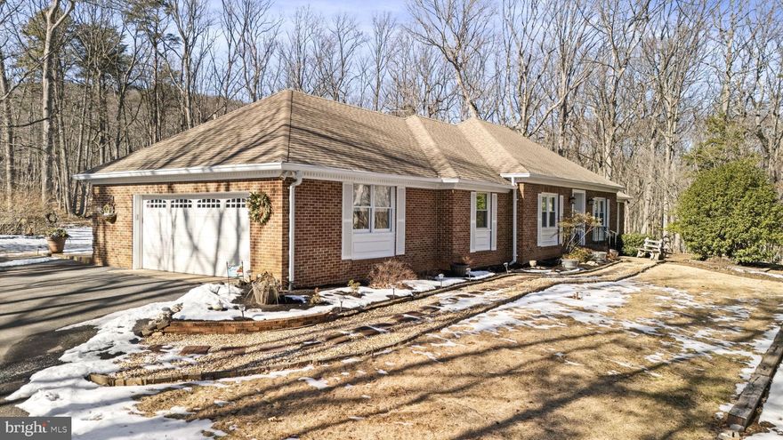 Welcome home to this beautifully updated three-level, all-brick rambler situated on a private 2.4-acre wooded lot. With over 2,700 square feet of finished space and the potential to expand to more than 4,600 square feet, this home is a rare gem—they truly don’t build them like this anymore! Thoughtfully upgraded and meticulously maintained, this home features a renovated kitchen and baths, updated exterior doors and windows, two masonry fireplaces, and sanded and finished hardwood floors throughout. The fully floored attic with walk-up stairs offers additional expansion potential, while the third level and basement include rough-in plumbing for future bathrooms. The 1,900+ sq. ft. walk-up basement provides endless possibilities for additional living space. The oversized two-car side-load garage includes a workshop area, and the screened-in porch with tile flooring overlooks the serene backyard, complemented by a large patio. An extra-large, flat paved parking area is perfect for parking or play. The renovated kitchen is a chef’s dream, featuring upgraded GE Profile appliances, glass subway tiles in a stylish herringbone pattern, lighted accent cabinets, Corian countertops, a separate pantry, pull-out drawers, a spacious island, and abundant storage. Please note: The tax records are incorrect regarding the unfinished space above grade. Offering privacy, space, and timeless quality, this exceptional home is not to be missed. Open House: 2/15 & 2/16 from 1-3 PM or by appointment.