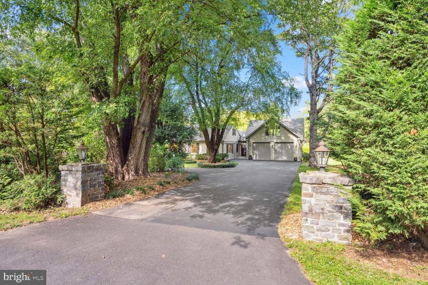 RARELY AVAILABLE RAMBLER COMPLETELY RENOVATED AND EXPANDED ON A SWEEPING 2-ACRE LOT JUST BLOCKS FROM POTOMAC VILLAGE !!  A BREATH OF FRESH AIR, THIS IMPECCABLE AND MASTERFULLY RESTYLED ESTATE  EXEMPLIFIES FINE LIVING AT ITS BEST WITH  TOP-TO-BOTTOM RENOVATION INSIDE & OUT,   OVER 5,000 FINISHED SQUARE FEET, 7 BR AND 5 FBA, PRIVATE CIRCULAR DRIVEWAY AND AMAZING LAVISHLY LANDSCAPED YARDS!
Greeted by stone piers and lanterns, the circular driveway is surrounded with mature trees and landscaped gardens. Bright and cheerful, from the two-story foyer to the beautiful hardwood floors throughout, the large formal dining and living rooms adorned with triple crown moldings, this home sets an unrivaled standard of luxury. A spectacular custom-built and insulated large garage addition with nearly 10ft hight ceilings, recess lights, wall of built-ins, and a side service door leads to an enormous upper-level room ideal as a separate office, media room or a home gym. Relax and entertain in the dramatic family room with vaulted ceilings, custom moldings, 2 sky lights, a wood-burning fireplace and 3 sets of sliding glass doors to the expansive deck. A chef’s delight this contemporary kitchen boasts vaulted ceilings, stainless steel appliances, 2 ovens, 2 dishwashers, a 7’8” X 7’2” quartz island, large pantry and sliding glass doors to the deck. With the convenience of main level living the Owners suite with picturesque views of the grounds offers 3 walk-in closets, triple crown moldings and an Owner’s bath with a quartz vanity top & frameless glass shower. Located on this wing of the home are 2 additional bedrooms and 1 shared full bath # 2. A private en-suite bedroom #4 & full bath #3 is located on the opposite end of the home ideal as a guest suite. Spectacular, the walk-out lower level offers wide plank hardwood flooring and a full kitchen #2 with a quartz island, stainless steel appliances, wine cooler, extensive 42” cabinetry as well as a spacious breakfast/dining room area. Ideal for informal or grand scale gatherings is the recreation room with a wood-burning fireplace and sliding glass doors to the covered flagstone patio. Completing this level are large bedrooms # 5, 6 and en-suite #7 with full baths # 4 & 5. Minutes from Potomac Village and the interstate corridor, this exquisite home will wow the most discerning buyers!