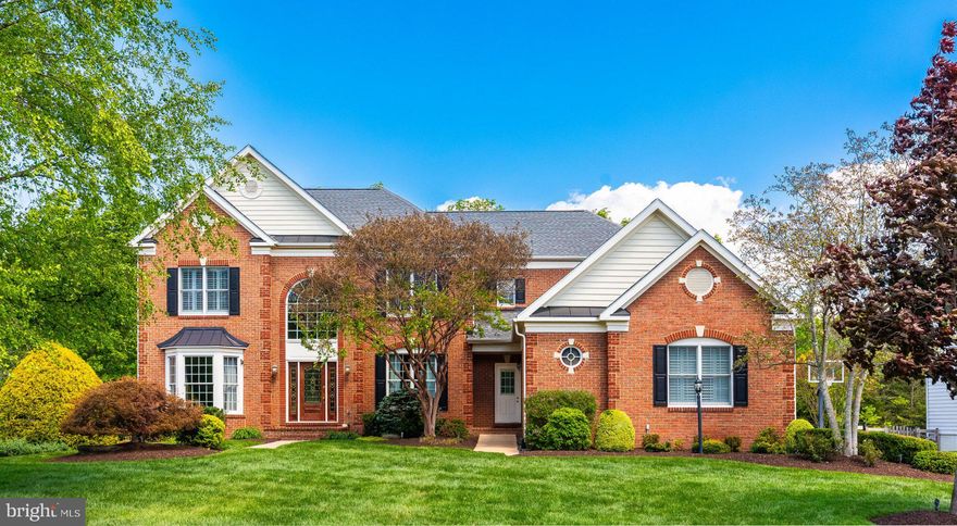 There’s a certain ease to this home the moment you arrive… where the setting feels quiet, the spaces feel open and elevated, and everything just flows effortlessly.

Perfectly sited on a premium .47-acre lot near the end of a quiet cul-de-sac street, this brick-front home backs to a beautiful stretch of mature trees, creating a sense of privacy that immediately feels grounding. From the three-car side-load garage to the lush, landscaped surroundings, the approach sets a welcoming tone before you even step inside.

A two-story foyer with hardwood floors and detailed moldings greets you, with formal living and dining rooms on either side, complete with crown molding, wainscoting, and a bay window that fills the space with natural light. As you move through the home, it opens into a sunken family room with a cozy gas fireplace, seamlessly connected to the kitchen and breakfast area… the kind of layout that naturally brings people together.

The kitchen is impeccably appointed with granite countertops, a center island with gas cooktop and downdraft, double wall ovens, and a vaulted morning room with skylight that fills the space with sunlight throughout the day. From here, the transition outdoors feels effortless, as the covered porch and tiered deck extend the living space in a way that makes inside and outside feel fully connected.

The backyard isn’t just an addition - it’s an experience. An in-ground pool and hot tub surrounded by flagstone, a built-in fire pit, and mature landscaping create a setting that feels both private and inviting. Framed by wrought iron fencing and a dense tree line beyond, it’s the kind of space where afternoons turn into evenings, and gatherings naturally linger a little longer.

Upstairs, French doors open to the primary suite, offering a tray ceiling, a quiet sitting room, dual walk-in closets, and a spacious bath with a jetted soaking tub, separate vanities, and a walk-in shower. Secondary bedrooms are generously sized, including a junior suite with private en-suite bath, and two additional bedrooms connected by a Jack and Jill bath.

The finished lower level adds another layer to how the home lives day to day. Designed with both function and flexibility in mind, it features a media area with projector and screen, a wet bar with beverage fridge and icemaker, and a full bath with steam shower. With direct access from the backyard, it’s an easy transition in from the pool. Additional rooms offer flexibility for guests, work, or hobbies.

Plantation shutters and zoned speakers extending to the deck add thoughtful detail throughout.

Recent updates include HVAC system with upstairs unit and furnace (2025), pool filter pump (2023), roof (2021), skylights (2021).

The amenity-rich community of South Riding offers pools, tennis and pickleball courts, walking and biking trails, a dog park, fishing pier, public golf course, and a clubhouse for private events. Conveniently located near schools, Paul VI campus, Dulles South Recreation Center, shopping, dining, and major commuter routes including Route 50, Route 28, the Dulles Greenway, and the Toll Road, with easy access to Dulles International Airport. Leesburg, Aldie, and Middleburg are just a short drive away for wineries, boutiques, and dining.

This is more than a home. It’s a place that feels easy to settle into, easy to enjoy, and one you’ll find yourself not wanting to leave.