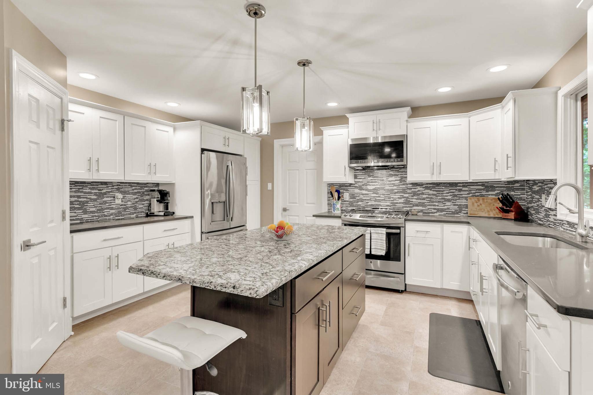 This stunning home is tucked away in a peaceful, sought-after neighborhood, offering the perfect blend of seclusion and convenience. From the moment you step through the grand entry, you’ll be captivated by the vaulted ceilings, bright and open floor plan, and elegant design throughout.
The heart of the home—the kitchen—is truly a showstopper, featuring high-end cabinetry, gorgeous countertops, a stylish backsplash, butler’s pantry, stainless steel appliances, and designer lighting. It flows seamlessly into a spacious family room with hardwood floors, large windows, and breathtaking views of the wooded backdrop.
Need a productive workspace? The private home office is both efficient and serene—ideal for remote work or study. The main level also includes a formal dining room, formal living room, and a sun-filled enclosed deck with electricity, perfect for morning coffee or evening relaxation.
Upstairs, you'll find generously sized bedrooms, all with ceiling fans and ample closet space. The primary suite is a true retreat, complete with a luxurious en-suite bath featuring a frameless glass shower, separate soaking tub, and elegant tile work. Every bathroom in the home has been thoughtfully updated with modern finishes and high-quality materials.
The fully finished basement offers even more living and entertaining space, plus tons of storage, a full bathroom, and walk-out access to your private backyard.
Step outside to enjoy the best of both worlds—privacy and space. The large yard is perfect for gatherings or play, and the combination of enclosed and open deck space makes outdoor living effortless year-round.
All of this is just minutes from shopping, dining, entertainment, and major commuter routes.