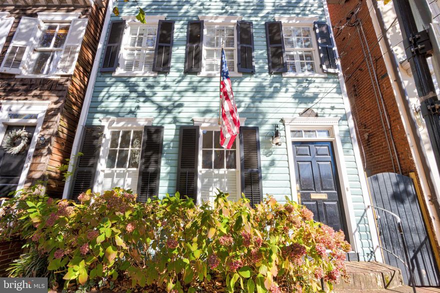 Own a Piece of Annapolis History – Don’t miss this rare opportunity to own an exquisitely restored historic home in the heart of downtown Annapolis. Welcome to The Quarter Deck on Prince George—a 4-bedroom, 2.5-bathroom retreat that blends timeless charm with modern convenience, all while boasting a proven short-term rental history. Financials are available upon request. This is the perfect opportunity for buyers looking to live in downtown Annapolis or they have a 1031 and need a quick move!

As you approach, you're welcomed by vibrant hydrangeas framing the elegant exterior. Step inside to discover brand-new gleaming hardwood floors flowing through the foyer, living, and dining rooms, setting the stage for a refined yet welcoming atmosphere. The grand entryway captivates with stately columns leading into a spacious living room bathed in natural light. At its heart, a stunning double-sided brick fireplace seamlessly connects the living and dining rooms—creating the perfect ambiance for intimate gatherings or cozy evenings by the fire. Step into a chef’s dream kitchen—fully equipped and thoughtfully remodeled to blend style and functionality seamlessly. Featuring elegant granite countertops and sleek stainless steel appliances, including a gas range, dishwasher, and spacious refrigerator, this kitchen is designed for both everyday ease and culinary creativity. Whether you're preparing a gourmet feast or a quick bite, this beautifully updated space makes every cooking experience effortless and enjoyable. From the kitchen, step outside into your fully fenced private backyard oasis—a serene retreat perfect for relaxation and entertaining. Whether you're sipping your morning coffee, hosting a summer barbecue, or unwinding under the stars, this inviting outdoor space offers the perfect blend of privacy and charm. Make your way up to the second level, where comfort and convenience await. This thoughtfully designed space features two beautifully appointed bedrooms, a spacious family room perfect for relaxing or entertaining, a fully renovated full bath with modern finishes, and a dedicated laundry room for added convenience. Whether you're unwinding after a long day or gathering with loved ones, this level offers the perfect blend of style and functionality.  Head up to the third level and prepare to be impressed. The expansive primary bedroom sits at the front of the home, bathed in abundant natural light, creating a bright and inviting retreat. Just steps away, indulge in the spa-like bathroom, complete with modern finishes designed for ultimate relaxation. A fourth bedroom completes this level, offering comfort and versatility to suit your needs. With its rich character, unbeatable location, and inviting warmth, this home is more than just a place to live—it’s a true Annapolis experience. 

Don't miss the opportunity to own a beautifully restored historic gem, just steps from the U.S. Naval Academy, City Dock, Ego Alley, and the vibrant shopping and dining scene along Main Street. Schedule your private tour today!