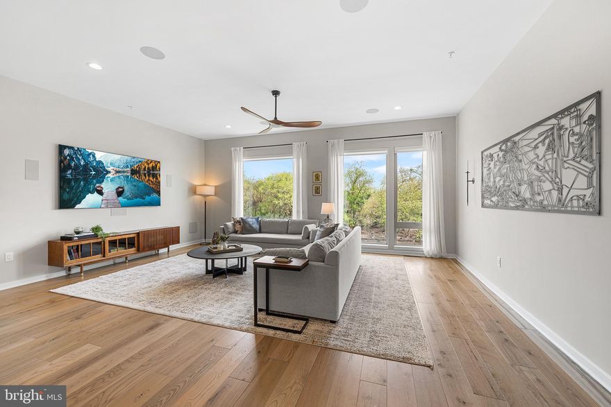 Welcome to 3117 Pierview Lane, a fully upgraded Essex model home in the highly sought-after Northbank community, offering rare, water views along the Delaware River. Unlike many homes in the neighborhood, this residence is perfectly positioned to capture unobstructed river views and an abundance of natural light, creating a peaceful, elevated living experience. Full video tour available—see media section. Enter on the first floor, where you’ll find a versatile space currently designed to function as either an additional bedroom or a private home office, complete with a full bathroom. This level offers flexibility for guests, work-from-home needs, or multi-generational living. Upstairs, the second floor opens into a stunning, light-filled main living area. The open-concept layout seamlessly connects the living room, dining space, and kitchen, all framed by impressive, and open water views. The living area offers ample room for entertaining, while the dining space easily accommodates an oversized table. The kitchen has been thoughtfully upgraded with a waterfall countertop, Wolf gas range and hood, Sub-Zero refrigerator, built-in microwave, stainless steel appliances, and custom roll-out drawers for optimal storage. A stylish dry bar with a wine cooler adds an additional layer of convenience and sophistication. A large pantry and powder room complete this level. The third floor features three spacious bedrooms, each with generous closet space and exceptional natural light due to the home’s unique positioning within the community. Two bedrooms share a well-appointed bathroom with a double vanity, while the third bedroom enjoys its own private en suite. A large laundry room is also conveniently located on this level. The top floor is dedicated to a luxurious primary suite. The bedroom is expansive and serene, paired with a spa-like bathroom featuring a rain head shower and freestanding soaking tub. A custom walk-in closet creates a true dressing space. Just outside the suite, a wet bar leads into a flexible bonus area, perfect for a home office, gym, or additional lounge space, all overlooking sweeping river views. Step out onto the private balcony to enjoy your morning coffee or unwind at the end of the day with the water as your backdrop. Continue up to the rooftop deck, where built-in speakers and panoramic 360-degree views of the city skyline and river create an exceptional entertaining space. This is the perfect place to take in Philadelphia’s skyline, waterfront sunsets, and fireworks. Additional highlights include a two-car parking garage, a private elevator servicing every level of the home from the ground floor to the rooftop, and in ceiling speakers throughout the main living floor, primary suite and deck. While the living room offers a 7.1 channel surround sound speaker system for maximum entertainment. The entire home is finished with upgraded hardwood flooring throughout in a warm, cohesive palette, and is supported by a two-zone HVAC system for year-round comfort. Located along the Delaware River, Northbank offers a unique balance of tranquility and city access, with a waterfront bike path connecting you to the rest of Philadelphia. Just minutes away are some of Fishtown’s most popular destinations, including Suraya, Kalaya, and La Colombe, along with neighborhood favorites like R&D Cocktail Bar and Secondhand Ranch. Experience waterfront living at its finest, with the perfect blend of luxury, comfort, and easy connection to city life. This property has six year left on a tax abatement!