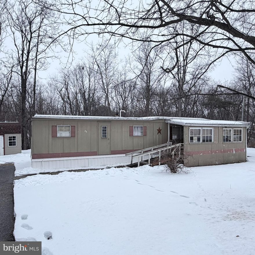 Nice opportunity to own versus renting! Check out this single-wide mobile home situated on 1.39 acres, offering two bedrooms and one full bath. Enjoy a spacious living area that flows into an open dining space and a bright, welcoming kitchen. The full bath includes a stackable washer and dryer, while the primary bedroom features two closets plus a built-in area perfect for getting ready. The rear shed will convey,