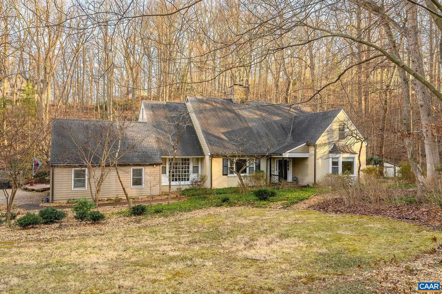 A Rare offering in Ednam Forest. Over two park-like acres and timeless curb appeal offer a balance of both privacy and neighborhood living. Sunny yard with meandering stream and an abundance of perennials, flowering shrubs and trees. Large rooms, 9 ft. ceilings, hardwood floors and a flexible floorplan allow for formal and informal spaces. Private first floor primary bedroom suite with separate office or small bedroom is completely separate from the public spaces. The spacious entry foyer provides great flow to the living room and den each with fireplace. Den with extensive built-ins opens to four season sunroom with access to the large deck, private hot tub area. The kitchen has a mudroom/laundry room entry off 2 car attached garage. The second floor has 3 additional bedrooms and multi-purpose space for a library/ game room, and a full bath. Abundant storage spaces and closets inc. third floor walk in storage room with cedar closet. Hightec synthetic Slate roof, plus copper roof for the Sunroom. Oversized copper gutters, Hardiplank siding and a propane, whole house generator. Walk to the Boar's Head Sports Club, Birdwood Golf Course and Rivanna walking trails. Murray Elementary, Henley Middle School and Western School district.,Fireplace in Family Room,Fireplace in Living Room