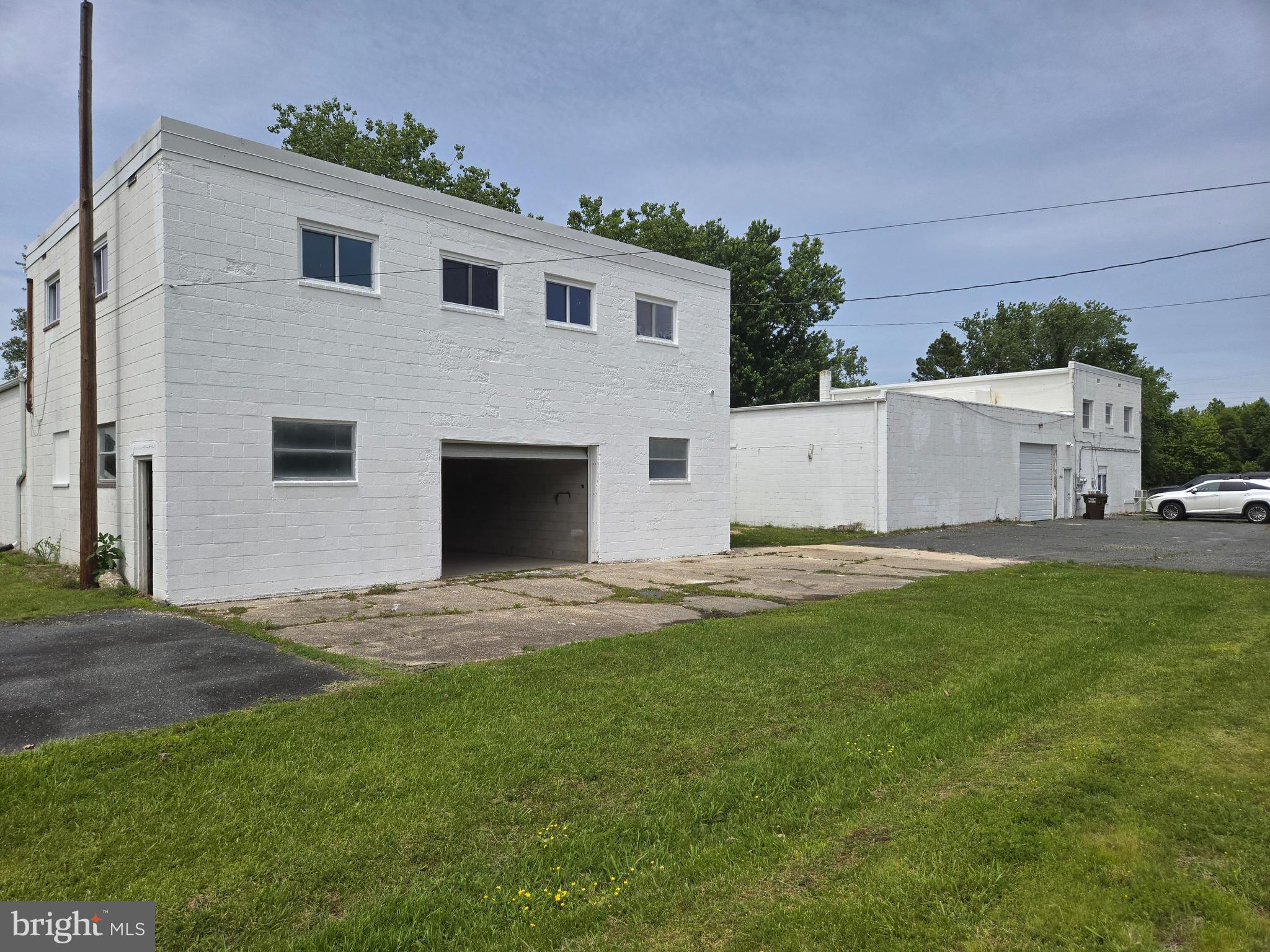 A bargain for two block buildings zoned General Commercial of 8,800 square feet with mixed used , adaptive use, and apartments, on second floors. Room for expansion on a .8-acre lot. Easy access to Ocean Gateway MD route 50 for transportation. Outside lot space in the back, front and sides is convenient to use. West building contains approximately 2,780 square feet of first floor space. The East building first floor space is of approximately 2,850 square feet with approximately 760 square feet as former offices and full bath. First floor ceilings with steel, truss girders are in both buildings. Height of ceilings from bottom of girders to concrete floors is approximately 11 feet. The West building apartment has recently been updated and is like new. The West building apartment is a 3 bedroom, 1 bath while the East building's apartment is of 3 bedrooms two baths where second full bath is attached to a bedroom. New roofs have been installed. Two new overhead garage doors have been installed as well. A survey and recorded Plat completed in 2022.