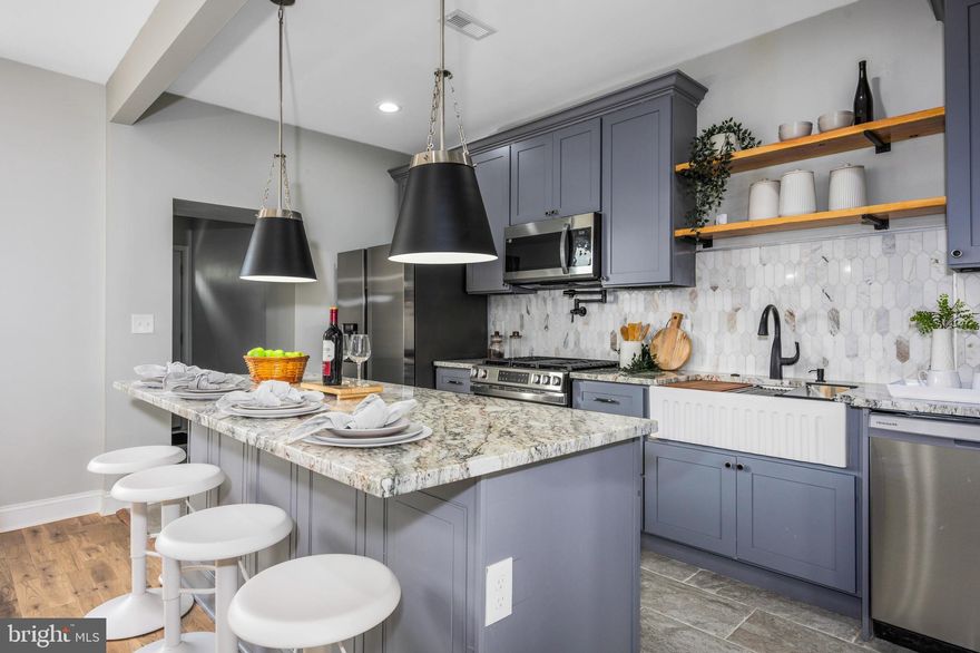 This fully renovated 4-bedroom, 2-bath home features brand-new electrical, plumbing, and HVAC systems, along with hardwood floors throughout (NO CARPET), and porcelain tiles in the basement. The modern kitchen is fully equipped with high-end finishes, and the finished basement includes an additional bedroom and full bathroom—ideal for guests or extended living space. Enjoy a private, fenced-in yard, a rear parking pad, and a welcoming front porch. Conveniently located near Morgan State University and Johns Hopkins University. Schedule your private tour today!