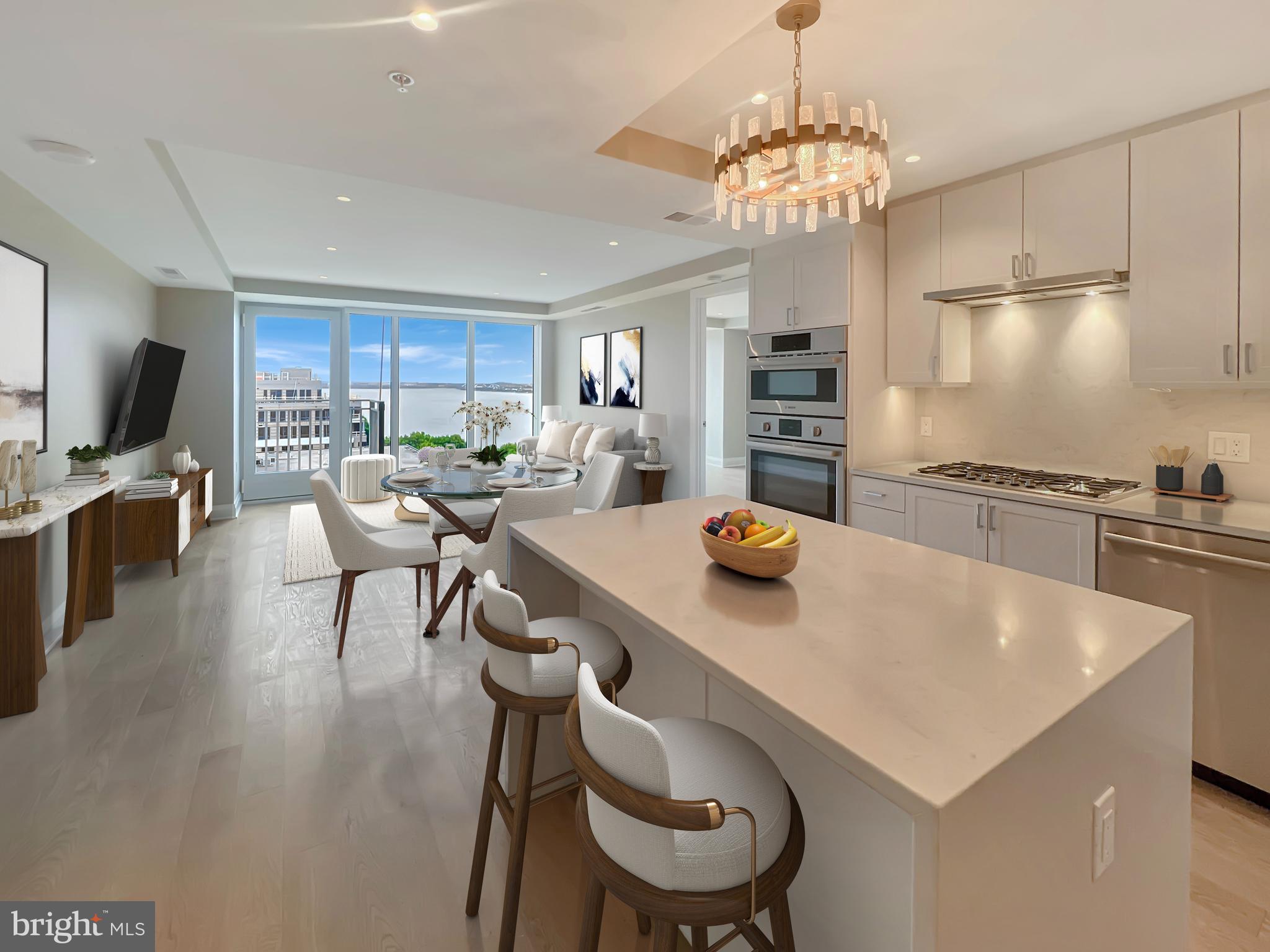 Perched on the 11th floor of The Venue—one of Old Town’s most desirable luxury buildings—this beautifully appointed two-bedroom, two-bath residence offers sweeping views of the Potomac River and the U.S. Capitol rarely found at this price point. As an added bonus, this residence includes 2 secure garage parking spaces AND a private storage unit—a rare combination that offers exceptional convenience and everyday ease.
The interior features a chef-worthy kitchen with Bosch appliances, quartz countertops, and custom cabinetry, opening to a bright and airy living space with access to your private balcony—perfect for morning coffee or evening sunsets. The spacious primary suite includes a double vanity, walk-in shower, and an oversized walk-in closet and a second closet, while 3 additional closets throughout the home provide exceptional storage.
The Venue offers an elevated lifestyle from the moment you arrive, starting with the porte-cochère entrance, grand lobby, and full-service concierge. Take in the stunning skyline from the rooftop terrace featuring panoramic views of DC, the river, and Old Town, complete with grilling stations and fire pit seating. Inside, the Sky Lounge offers a stylish entertaining space with flat-screen TVs, a fireplace, and cocktail bar. Residents also enjoy access to a state-of-the-art fitness center and barre studio.
Ideally located in North Old Town, just steps from restaurants, shops, the waterfront, and the Mount Vernon Trail—this home is the complete package.