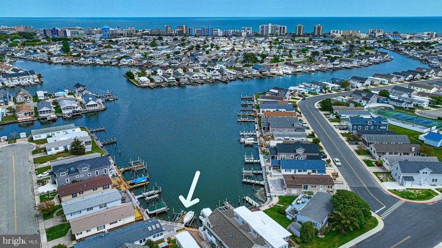 Price Reduced! 100 Sea Lane Ocean City, Maryland has direct waterfront access and expansive views on one of the best and largest bayside waterfront canals in Montego Bay! Sweeping open water views and dedicated docking for two boats. Enjoy docking right at your front door. This home features 3 beds 2 baths, huge waterfront outside deck, spacious open kitchen, family room with water views, and a large attached shed for storing all your beach toys. Renovate this beach house and make it your perfect getaway.  Needs some kitchen appliances and washer/dryer. Condition of hvac is unknown. Missing some decking boards. Check out all the community amenities in Montego Bay for a very low annual HOA fee of just $360 a year!! Enjoy 2 outdoor pools, tennis facilities, shuffleboard, and crabbing pier. Close to restaurants, shopping, mini golf, and city bus. Home and two boat lifts are being sold As-Is. Evidence of water damage in the front room ceiling.