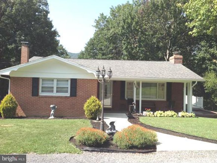 Nice brick ranch 3bd and 2  baths. The lot includes an extra parcel in the back that makes a total .50 +/- acres. Living room has a gas burning fireplace & the family room has a wood burner. The home is heated with natural gas and has central air. Newer deck over looks wooded lot. There is a 1 car attached garage & a 14 x 32 Esh's  garage. This home is close to schools and shopping.