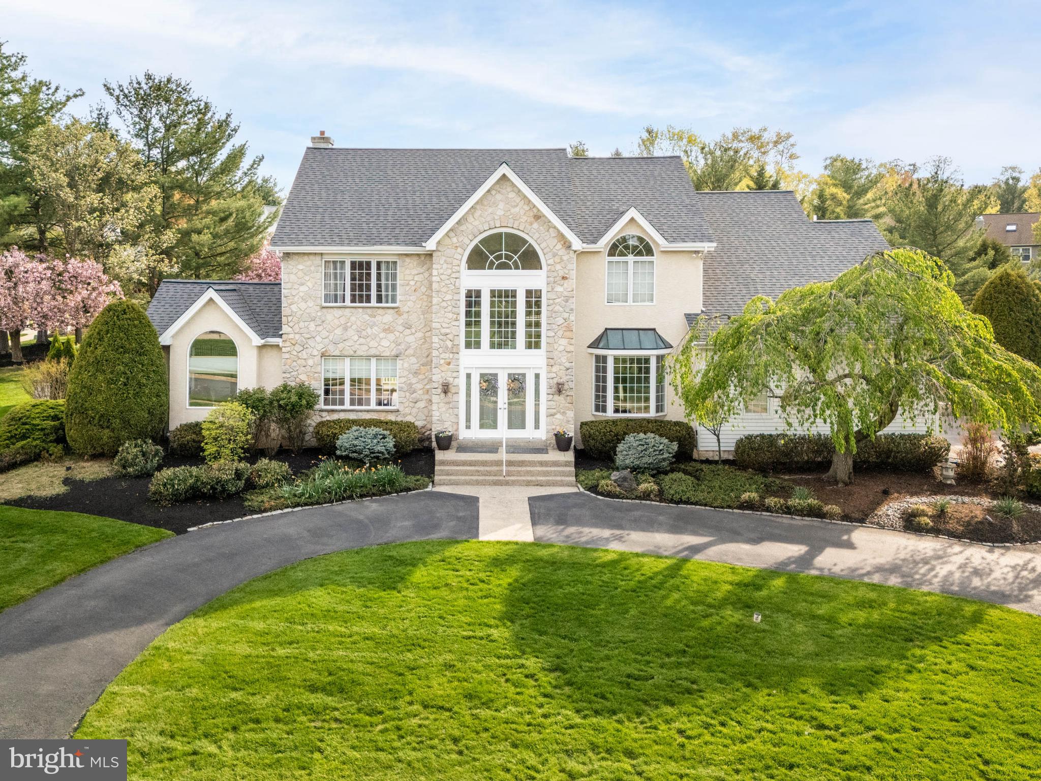 This Is the One—Welcome to 270 Kerry Lane, Blue Bell
Tucked away in the exclusive enclave of Estate Homes of Whitpain, this stunning residence sits on a quiet cul-de-sac in the heart of Blue Bell—offering luxury living within the top-rated Wissahickon School District, and no HOA fees.
Set on a non-through street and framed by a circular driveway, this elegant home offers over 4,000 square feet of finished living space across three levels, with 5 bedrooms, 4.5 baths, and three beautifully designed outdoor living areas.
Step through the double front doors into a grand two-story foyer flanked by a formal dining room and a gracious living room with rich oak hardwood floors. Beyond French doors, a large private office or library boasts soaring ceilings and an arched window that fills the space with natural light—ideal for work or quiet reading.
The open-concept layout is designed for seamless entertaining. The family room, anchored by a dramatic stone fireplace, flows into a chef’s kitchen featuring custom cabinetry, granite countertops, ceramic tile backsplash, a spacious center island with induction cooktop, and premium GE Monogram stainless steel appliances. A laundry/mudroom with pantry, access to the 3-car garage, and rear yard adds convenience just off the kitchen.
Upstairs, retreat to the primary suite with a cathedral ceiling, Juliet balcony overlooking the newly fenced backyard, and a custom walk-in closet. The primary bath features a whirlpool tub, double vanity, shower, and a second laundry area. Three additional generously sized bedrooms (including one en suite) and a hall bath complete the upper level.
The lower level offers a 5th bedroom and full bath—perfect for guests or an au pair—plus a recreation area, wet bar, entertainment space, and ample storage.
Outside is the area where everyone will want to be! Enjoy three distinct outdoor living areas: a private paver courtyard patio, a composite deck, and a covered outdoor kitchen and bar with stacked-stone double-sided fireplace, granite countertops, and mounted flat screen TV—an entertainer’s dream.
Located just minutes from downtown Ambler, the Plymouth Meeting Mall, and major roadways, 270 Kerry Lane offers the rare combination of privacy, elegance, and convenience. Don’t miss the opportunity to make this exceptional home "the one."