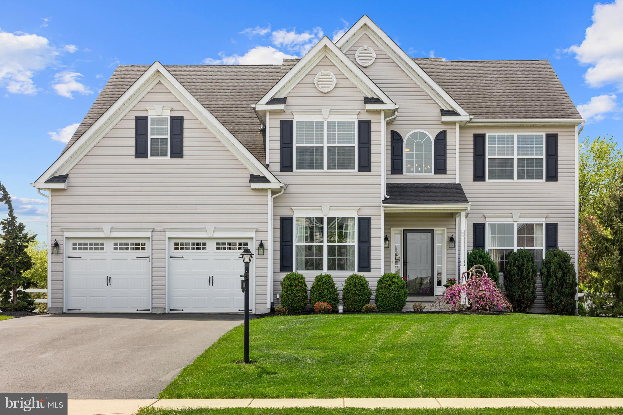 Impeccably maintained, sun-filled 2935 square foot home, situated on a premier .35 acre lot in walkable Rosenberry Ridge, has been thoughtfully and cohesively designed and finished, with open concept, connected rooms that welcome an abundance of natural light throughout the day, and a fully fenced backyard oasis that is framed by lush, mature landscaping. This original owner home has a modern, neutral, clean aesthetic that beautifully compliments and elevates its well-proportioned rooms that feature 9 foot ceilings, plentiful windows (some arch topped) and gorgeous wrought iron Pottery Barn lighting fixtures and window treatments throughout. The gracious floor plan unfolds from the open, two-story foyer, with upgraded chandelier and stairway spindles, and gleaming hardwood floors that lead past a well-positioned home office with french doors, the main level powder room with upgraded vanity, and into the open concept eat-in kitchen and family room. The eat-in kitchen is light and bright, with granite island and counter tops, 42" maple cabinets, stainless steel appliances and lovely pendant lights, and is loaded with efficient work spaces and storage, including a large pantry. The adjacent family room features a gas fireplace and is wrapped by windows on two sides that invite the outdoors in and showcase the mix of mature deciduous and evergreen trees that create a green fence around the rear of the property. Access the beautiful outdoor space via the kitchen sliders that lead to a 600 square foot stamped concrete patio, with Seneca limestone seating wall and lovely spaces for lounging, dining and outdoor entertaining day into the night, with integrated Kichler LED lighting that illuminates the outdoor stairs and patio after dark. Back inside, family and friends will love gathering in the living room that is open to the formal dining room, accented with crown molding, chair rail, and a well-scaled, statement chandelier. Atop the stairway, the generous primary ensuite is positioned for privacy. Double doors access this sanctuary, with tray ceiling, large sitting area, ample walk-in closet, along with an ensuite bath with dual sink vanity, soaking tub and walk-in shower. Adjacent to the primary suite is the convenient upper level laundry room with laundry sink, along with three well-sized bedrooms and a large hall full bath. The unfinished lower level of the home is a tremendous opportunity to add even more customizable living space and features a double-welled walk-up to the rear yard with already installed sliders, along with 9 foot ceilings. This exceptional property provides all the conveniences of proximate access to shopping and major regional thoroughfares, including Routes 422, 100, 663 and 73, and is located in sought-after Boyertown School District. Come appreciate all this amazing property has to offer!
