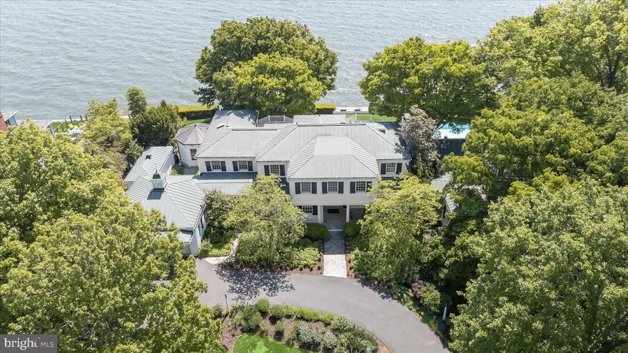 Sited along the storied Chesapeake Bay, with breathtaking views, proximity to the water, and exceptional landscaping, this spectacular Gibson Island listing offers a once in a generation opportunity to capture and enjoy the unique marvels of life along the Bay. The five-bedroom, five and a half bath estate, sitting on a rare double lot, offers generous living spaces and a timeless casual elegance perfectly suited to its idyllic location. The house also overlooks expansive stone terraces, lovely seasonal flowers and grounds, and a 63-foot heated lap pool with 180-degree panoramic views of the Bay.
Built in 1928 and beautifully renovated and expanded over time, the interior of this spectacular home unfolds with gracious rooms, inviting gathering places, classic architecture, a restful and spacious primary bedroom suite, superbly designed Bayside porches, hardwood floors, a main level guest bedroom with separate entrance, and a host of unique features and amenities befitting such a stunning property. The rooms offer carefully designed finishings that speak to both entertaining and comfortable family living. A property of this caliber and scale—combining a cherished residence, exceptional waterfront positioning, and a double lot—rarely comes to market on Gibson Island. With the Bay Bridge in the distance, it stands with the finest examples of Chesapeake Bay and Gibson Island waterfront property.

Information on Gibson Island:
Gibson Island is a private island within one hour of Washington, D.C. and Baltimore offering an absolutely extraordinary setting.  The Island comprises 1000 acres with seven miles of shoreline. Two thirds of the Island is undeveloped and is owned by the Gibson Island Corporation, the homeowners' association.  The remaining third is residential home sites. 
Gibson Island is located on the western shore of Maryland, so there is no need to cross the Bay Bridge. On the Island is a 43-acre spring fed freshwater lake in which one may enjoy non-motorized watercraft activities such as paddleboarding, canoeing, kayaking, fishing and swimming.  
The Island offers enormous privacy and security--there is an entry gatehouse staffed 24+Hours, and the Island is patrolled by the Gibson Island Police Force (GIPD).  The Gibson Island Corporation Service Department offers yard maintenance and landscaping and other services for homeowners.  There is a full-service yacht yard.   From the Island, it is just a 20-minute drive to BWI Airport and the neighboring Amtrak train station.  
The Island houses a private country club (membership by invitation) offering yachting, fine dining year-round, tennis, an award-winning Charles Blair Macdonald designed 9-hole golf course, swimming, croquet, skeet shooting, and more.  (C)