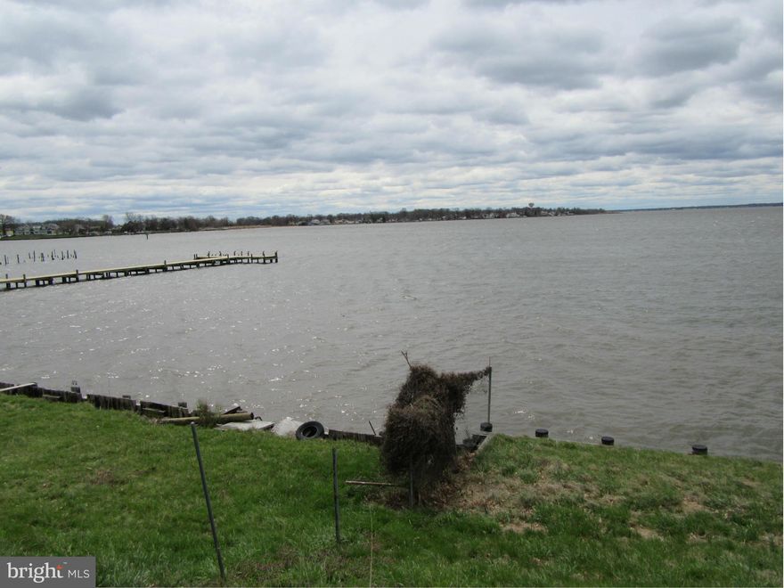 NEW PRICE $$  for  lot on the Chesapeake Bay "WHAT A VIEW" .A spacious red brick two story home with fire damage has a two car attached garage. Home has to be taken to a shell but the renovation would be AWESOME.. the lot is 100 ft by 578 ft. 100ft bulkhead and pilings for a pier Buyer can verify with Balto County for possible subdivision of this1.32 acre lot.. It has public water and sewerage