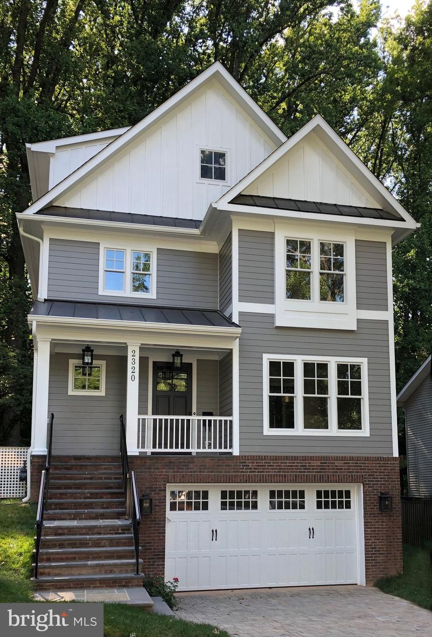 **Price Reduced to an exceptional value! *****Sited on a wooded lot  in the sought after Lee Heights neighborhood, this  new Spring Street home offers four finished levels and a versatile floorplan.  Lower level rec room and 5th bedroom have separate laundry area and plumbed and wired for kitchenette.   With a private entrance, it is ideal for an in law, au pair, or income producing English basement rental.   Walk to shops, restaurants, schools.   "Two lights to DC"  convenience, plus Donaldson Run swim club area.*********Inviting foyer leads to living room or traditional dining room with adjoining butler's pantry and walk-in kitchen pantry. Double doors with sidelights  in family room lead to private, flat yard with mature trees and shrubbery.  A true oasis yet blocks to Starbucks! ***Breakfast area, gorgeous kitchen, and family room span back of home and offer private views.***Upstairs, the master bedroom features an en suite bathroom with double bowl vanity and  soaking tub along with a walk-in closet with organizers.  Two more bedrooms, bathroom, and laundry room with washer and dryer complete this level***The top floor is given over to a big bonus room with dormered ceilings, the fourth bedroom and bathroom.***In the lower level, the oversized two car garage has entry to a mudroom with built-ins (even electronic device chargers),**Wood floors main and upper level, gas fireplace  in family room; extensive moldings, wainscoting, quality details, and thoughtful touches that are the hallmark of a Spring Street home.*******.