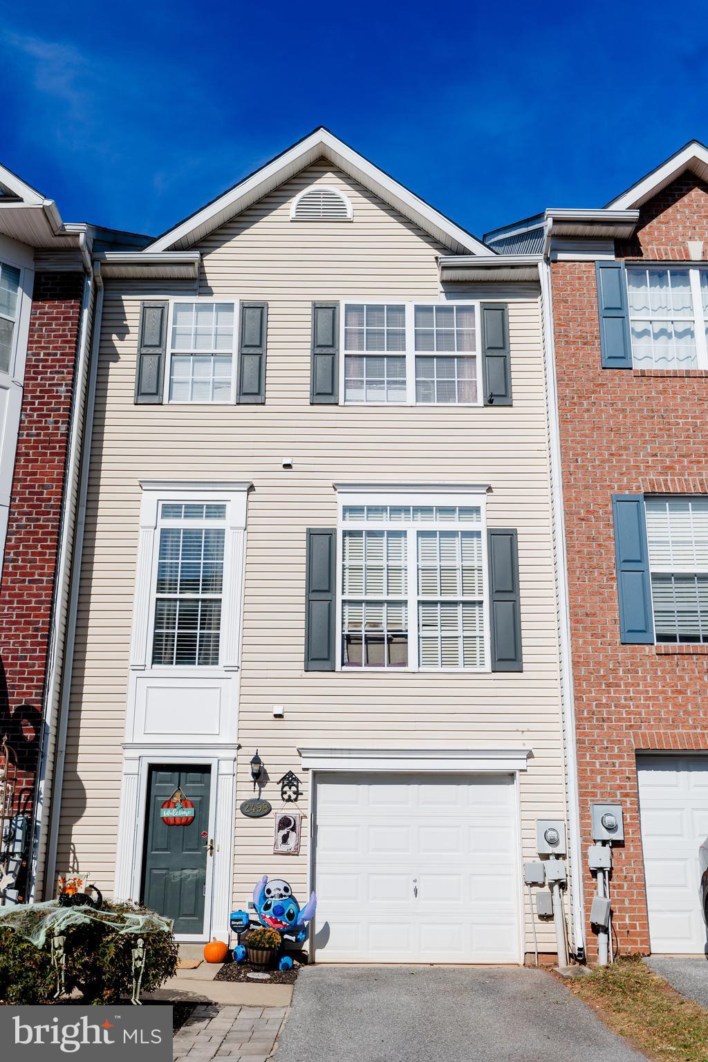 Welcome home to your peaceful retreat. This three level three bedroom garaged unit shows the pride and love of ownership. Beautiful natural light with East-Northeast facing property. Lower Level entry has a powder room, hall and large family room with fireplace and walk out to a fenced yard with patio. The main level has gleaming hardwood floors with an open LR DR floor plan. Eat-in kitchen with sliders to deck for extra entertaining. Owner's suite with w/i closet and full bath, two large secondary bedroom with hall bath. All appliances convey, New roof 2023, Fridge 2020, W/D 2022, New countertops 2021.