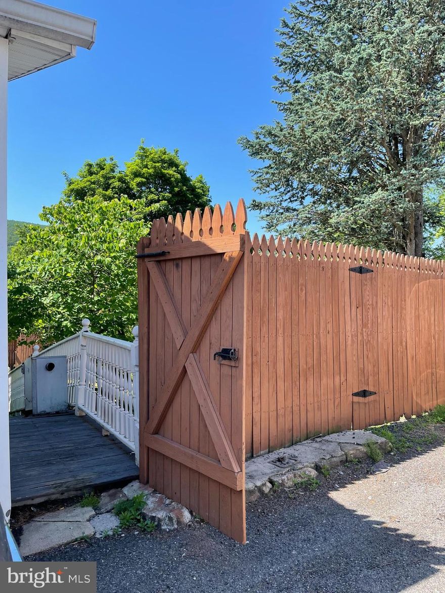 Endless  potential!!! This is 2 parcels (70-003-31, 70-003-32). 127 E. Market additionally has commercial zoning. Build an office, build a home, build rentals. Their is a handicap spot right out front. This yard has beautiful mature pear and cherry trees. Back yard is spacious and private with partially fenced mid property, runs along alley and to opposite side of garage. Walkway up to garage with 2 lockable access doors. Ramp to back gate. Garage has furnace and is currently run by generator. Public water, public sewer, and electric are all available. Fabulous view of the mountain from the back yard! If you can't buy something ...this is the perfect spot in town to build something. Garage is currently being rented by Sellers and is a potential source of income to new buyers.