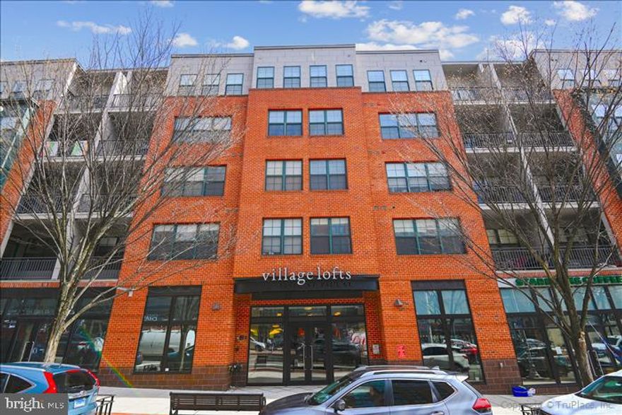 This is the perfect opportunity to purchase your own little piece of real estate – and what a purchase it would be!  The Village Lofts is a fabulous condominium in the heart of the Johns Hopkins University community.  In addition to the premier location, this condo offers so many amenities and modern-day conveniences.  It’s a perfectly sized one bedroom that is AWASH in natural light.  It faces South and East so the sun pours through every bank of windows.  The updated kitchen opens to the living room – and a darling balcony is the ideal setting to enjoy the views and fresh air.   The sun-filled bedroom and attached bathroom are nicely offset from the living space, and a powder room and laundry room are bonus treats.  All of this and the wonderful amenities  of  designated parking, a secure building and a vibrant community!