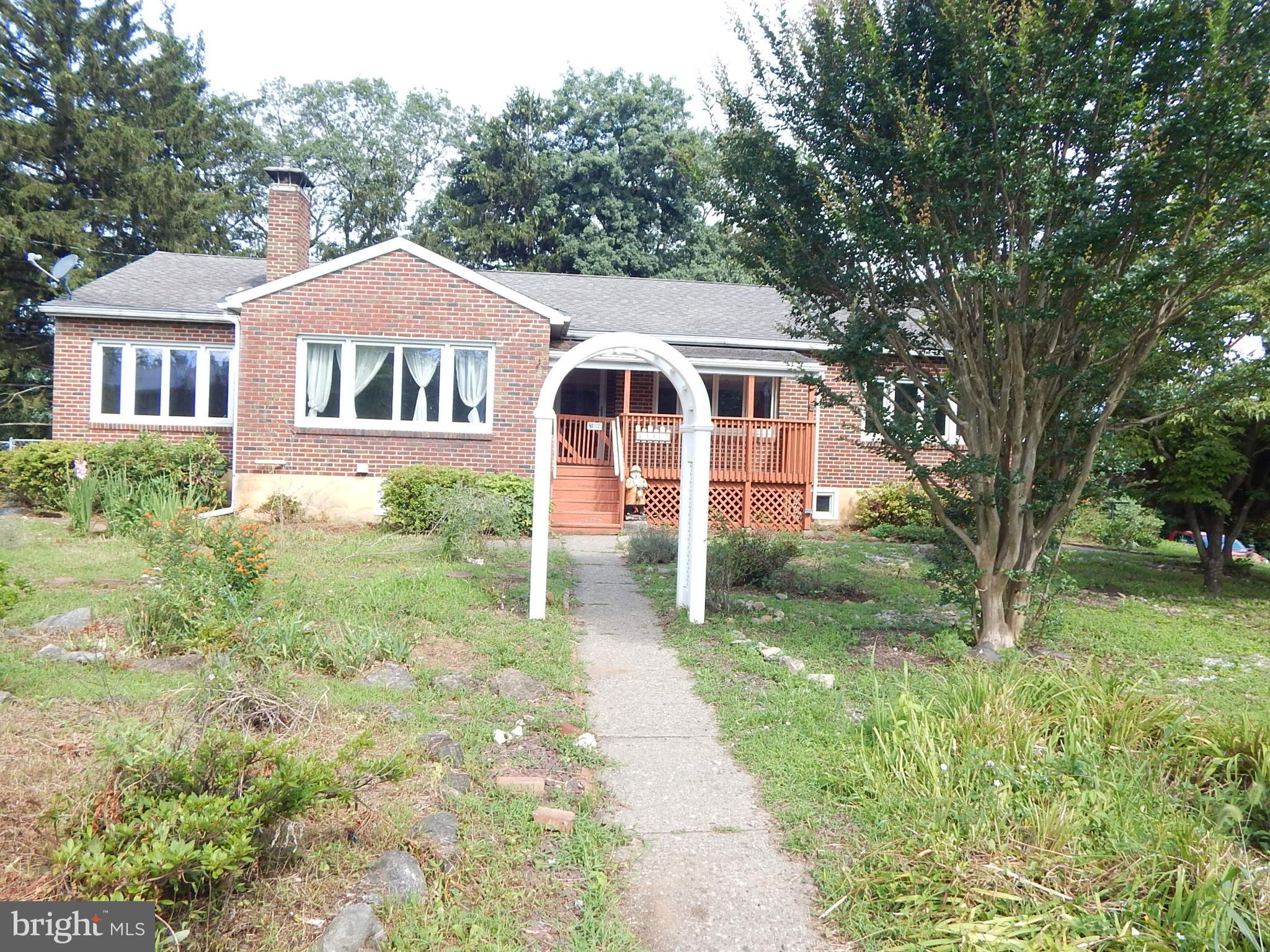 All brick ranch 2,448 sq ft on half an acre that offers 3 bedrooms and 2.5 baths. The home has hardwood floors flowing through out and tile floors in the kitchen and bathrooms. Living room has a wood burning fireplace, rounding into the dining room, then a big eat-in kitchen with a glass top stove and a newer stainless steel refrigerator. Three bedrooms one with a cedar closet. An in law suite that has living room, kitchen, full bath and a large bedroom with access to the deck. Enclosed porch that also leads to the deck. There is a laundry chute in the hallway that exits in the laundry room in the basement that also has a utility room with the air handler for the central air conditioner, on the wall a newer efficient natural gas hot water furnace for the hot water and (VELOCITY) heating, there was a French drain system installed with two sump pumps. Electric 200 amp panel and a sub panel in the work shop is all updated. There is a full bathroom, a finished room and a large work shop. Paved drive way with three car garage and car port. The garage has two garage doors, the third one is a standard door all three with electric openers. A nice fenced backyard with garden shed. Home needs some TLC with the deck needing some work but a very nice home. Seller wishes to convey the property in as-is condition. Easy access to Rt. 33, 22 and 78. Don't hesitate make your appointment today.