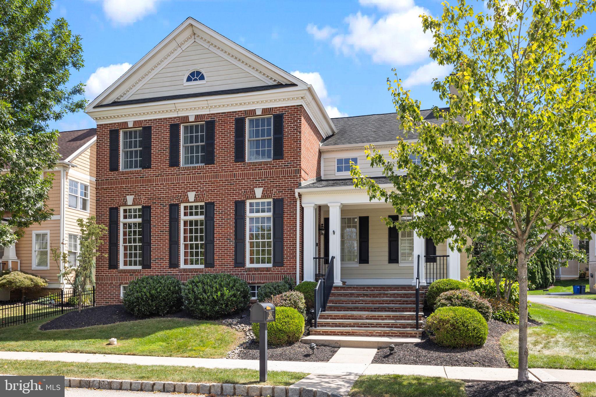 Located in the sought-after Woodmont community, this beautifully designed Georgetown model sits gracefully on a corner lot with tranquil pond views and is just a few steps from the scenic Pennypack Trail. With its inviting front porch and tree-lined streets, the home offers the perfect blend of elegance, comfort, and modern convenience. Inside, the open layout features gleaming hardwood floors, soaring ceilings, and sun-filled living spaces. A formal dining room with butler’s pantry flows into the expansive great room, highlighted by a gas fireplace and walls of windows. The gourmet kitchen is truly the heart of the home, boasting high-end appliances, a large center island, two walk-in pantries, and abundant cabinetry, all seamlessly connected to the breakfast area and Trex deck. The first-floor primary suite provides a private retreat with a tray ceiling, two walk-in closets, and a spa-inspired bath with soaking tub, oversized shower, and dual vanities. Upstairs, two spacious bedrooms share a bright Jack & Jill bath. The finished walkout basement featuring a large sitting room, full bath, and two additional bonus rooms, also an expansive open space ideal for recreation, fitness, or hobbies. Outdoor highlights include sprinkler system, lighting, oversized 2 car garage, and a security system.. Added upgrades such as a whole-house generator, 200-amp service, zoned HVAC, and fresh updates make this home truly move-in ready. This Woodmont gem offers the perfect combination of style, space, and community living.