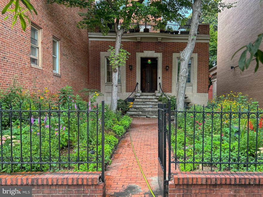 Historic Home in the Heart of Baltimore's Architectural Center
This restored mid-19th century home is a rare opportunity to own a piece of Baltimore's rich history.  Originally built in the 1850's for the daughter of the then Attorney General of Virginia, the residence has been lovingly restored to preserve its history while introducing modern luxuries.
Elegant and Versatile Private Suite on First Level:  A Seamless Blend of Home and Work
Upon arrival, the grand double mahogany entryway welcomes you into a sophisticated flagstone floored large reception room, that leads to a beautifully designed, self contained space with 3 large rooms, 2 powder rooms and a well appointed  2nd kitchen.  Ideal for a studio, gallery or executive office and  provides the perfect setup for work-from-home professionals or creative entrepreneurs.
The second floor showcases a gorgeous parlor with high ceilings, period details, a working wood burning fireplace, and floor to ceiling windows.  The large gourmet kitchen is stunning, designed by a local artist, with  top of the line 6 burner Bertazzoni  gas stove and exhaust, farmhouse porcelain sink, ceiling height custom cabinets, large windows overlooking a charming courtyard. A magnificent adjoining dining room seamlessly flows out to an expansive roof terrace---a peaceful retreat that feels miles away from the city bustle, and is ideal for hosting unforgettable gatherings. On the rear 2nd level is an office/bedroom, with beautiful new full bath and walk-in shower. 
The third floor features two spacious bedrooms, each with an en-suite bath, offering privacy and comfort. The tasteful primary full bath features a porcelain soaking tub, brass fixtures and marble floor. Beautiful light abounds from all of the windows!  The brick and mature gardens, both front and side, are absolutely lovely! Wrought Iron details on the upper roof terrace are amazing! Off street parking for 3 cars...a rare find! EV charger in rear parking area makes electric vehicle ownership seamless.  Located just half a mile from Penn Station, with easy access to Washington, DC, Philadelphia, and NYC, this beautiful home is perfectly positioned and the neighbors are superb...Walter's Art Gallery, Baltimore Symphony Orchestra, Peabody Library,  Center Stage, Fine Restaurants, Historic Parks and the Original monument to George Washington!