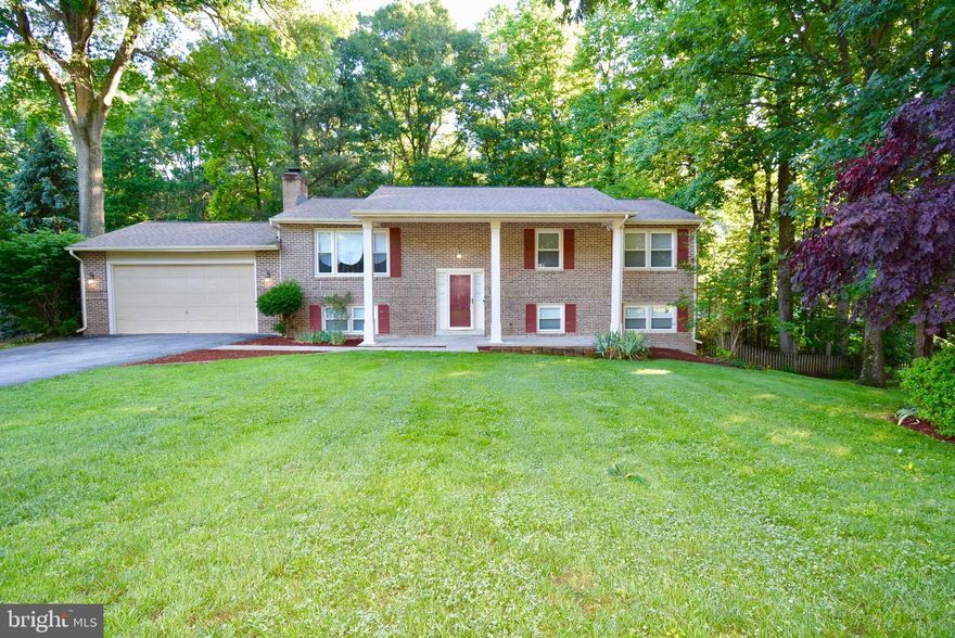 HOME QUALIFIES FOR USDA 100% FINANCING! Home sweet home! Beautifully maintained split foyer is a must see! Gorgeous, spacious and updated, this home has over 2800 sq. feet of living space and a backyard that is perfect for entertaining. Split foyer entrance has hardwood foyer and slightly swirl staircase that leads to an all hardwood floor upper level. The open floor plan has separate living room, dinning room and kitchen area. Living room has large windows that bring in natural sunlight. The dining room has chair and crown molding and has sliding door that leads to all weather sunroom.Enjoy cooking in this large beautiful kitchen with ceramic tile, updated appliances with lots of cabinet and counter space.  Master bedroom has full updated bathroom, ceiling fan, walk in closet with closet organizers and crown molding. Home has two (2) additional bedrooms that have large closets and ceiling fans. Lower level is great for entertaining. Large recreation room features all brick fireplace, built in brick bookshelf and upgraded carpet. Recreation room also has custom built bar.  Additional lower level rooms include 4th bedroom, full bath, bonus room, laundry room and office.  Large fenced backyard is great for those family cookouts. Relax and enjoy the in ground pool, hot tub, gazebo and deck that overlooks the amazing shaded back yard. Home has two car garage and is close to shopping, restaurants, transportation , DC Metro area and more.