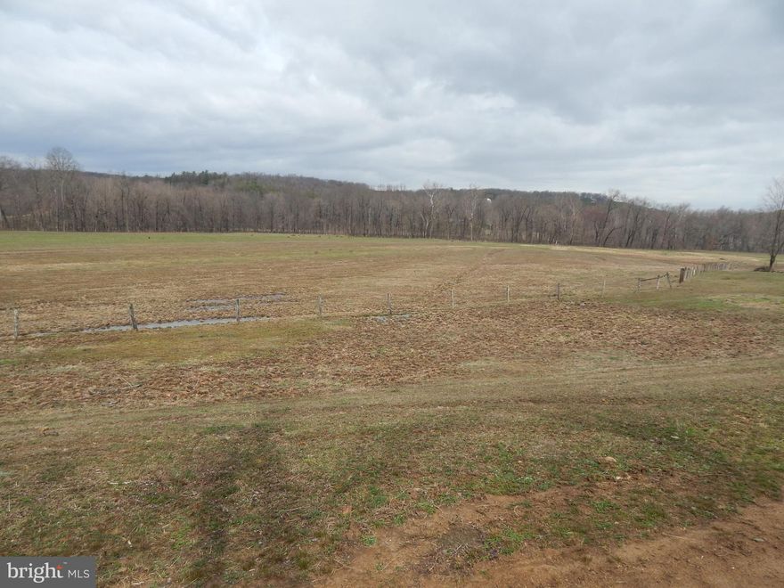 16.775 Acres with County Road  frontage and  over 900' frontage on the Sleepy Creek.   Pasture land with fencing  and mountain views.   Land is surveyed and perced.  Perfect land for your own farmette.   Doublewides, horses, cows and chickens allowed.  Seller will add 3 deed restrictions.