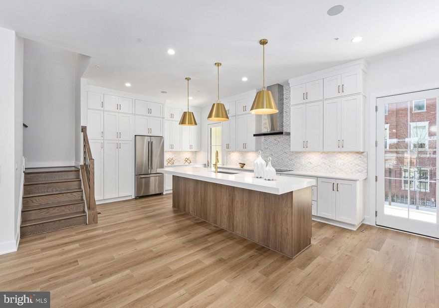 This home offers an exceptional fusion of sophistication and comfort across four expansive levels, elevating your lifestyle at every turn. The inviting foyer sets the tone for the home, leading into a versatile flex room that can be customized to suit any need. On the first floor, a bedroom with a full bath provides convenient guest accommodations. An elevator serves all levels, ensuring ease and accessibility. The second floor opens to an airy great room and a casual dining area, both bathed in natural light from a stunning balcony. The chef-inspired kitchen is equipped with stainless steel appliances and features a spacious island with a breakfast bar, abundant counter and cabinet space, and access to a charming covered deck. A well-appointed butler’s pantry off the Great Room offers an ideal space for storage and entertaining. Throughout the home, elegant oak-stained stairs have been added with sleek horizontal iron railings providing a timeless touch, adding to the home's refined aesthetic. The third floor houses the serene primary suite, complete with a generous walk-in closet and an elegant bath that boasts a dual-sink vanity, a luxe shower with a built-in seat, ample linen storage, and a private water closet. The suite is further enhanced by a soffit ceiling, adding to the sense of space and tranquility. Two secondary bedrooms, one with a walk-in closet, share a beautifully appointed full bath with a dual-sink vanity. The fourth floor features a remarkable rooftop terrace, perfect for entertaining or relaxing, with a cozy fireplace and a retractable awning to enjoy the outdoors in comfort year-round.