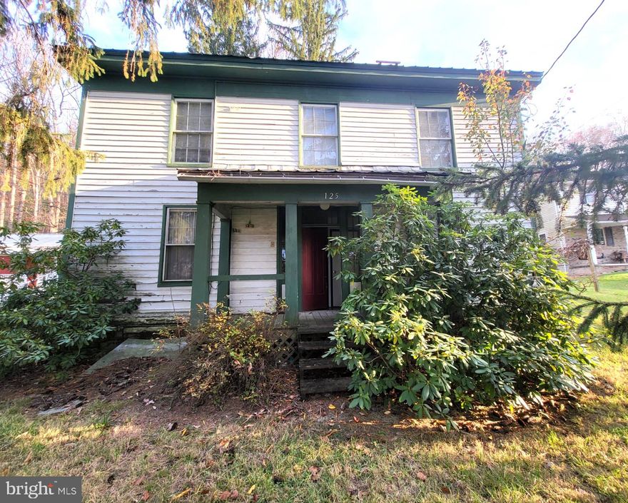 This charming 4-bedroom, 1-bathroom Colonial home in Wardensville, VA, needs significant work but offers great potential for those looking to restore a classic beauty. Featuring original brick details, wood trim, and three classic fireplaces with mantels, the home exudes historic character. A cozy front porch welcomes you, while a rear veranda and second-floor balcony provide additional outdoor spaces to enjoy the surrounding views. Situated on 0.83 acres, the property is just minutes from W Main Street, where you'll find several highly-rated local eateries. For those seeking a mix of small-town charm and easy access to city amenities, this home is located only 45 minutes from the bustling city of Winchester, VA. All offers considered; sold As-Is.