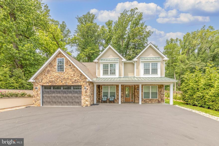 Welcome home to this handsome West Chester Colonial! Just 3 years old, it still smells like new construction and since it was designed and built by a builder, you know only the highest quality materials & craftsmanship were used. The exterior boasts a classic stone facade, durable hardiplank siding and an inviting covered front porch with standing seam metal roof. The first floor office is flanked by a sun-splashed dining room with butlers pantry, plenty of cabinets and a beverage fridge. The sleek yet classic white kitchen opens to the two story Family Room and offers top of the line appliances including Fulgor Milano induction range & range hood. The Dacor fridge, microwave & dishwasher are showstoppers and so are the glass front upper cabinets, massive kitchen island & top of the line countertops. Sunny breakfast room offers access to the back patio with two retractable awnings where you can enjoy the flat private back yard. The Family room features a wall of windows, beautiful natural stone fireplace & hardwood floors. You’ll love the first floor owner’s suite with gorgeous bathroom offering an oversized tile shower, soaking tub and dual vanities with additional cabinetry on either side. The main floor is completed by a massive laundry room with a wall of cabinets, laundry sink & Speed Queen washer & dryer. Ascend the steps to the second floor OR just use the  elevator! On the second floor you’ll find an in-law suite complete with kitchenette, dining area, living room, bedroom & bathroom. The in-law bath is handicapped accessible offering a roll-in shower. The second floor is completed by 3 additional bedrooms, 2 more full bathrooms & a bonus room that would be perfect for a 2nd office, exercise room or storage. Other features you’ll enjoy include recessed lighting everywhere, gorgeous engineered hardwood or tile floors throughout & beautiful modern lighting fixtures.