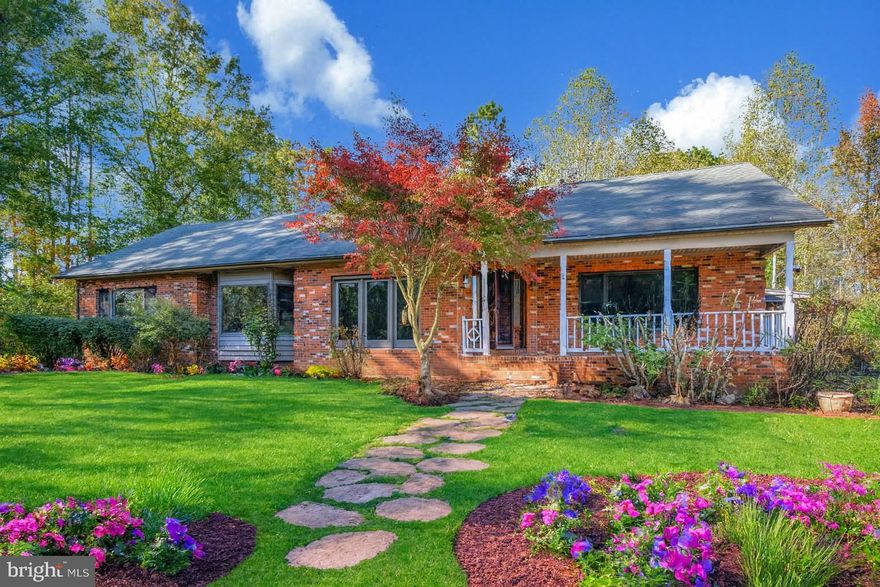 WELCOME HOME to a serene retreat nestled on nearly 7 total acres, roughly 6 acres of mature hardwoods, in the heart of Spotsylvania, Virginia. This expansive custom all brick ranch, built in 1993 and remodeled in 2025, features approximately 4,400 sq ft of living space and offers 3 bedrooms and 3 full baths—providing the rare blend of country-quiet with being less than 10-minutes from the I-95 exit 118 in Thornburg, Dominion Raceway, Kalahari In-door Waterpark Resort and Conference Center.  Approximately 30 minutes from restaurants and shopping in Central Park, Spotsylvania Town Center, Downtown Fredericksburg, 50 minutes to Richmond, and 90 minutes to Washington, DC.

The interior is freshly updated and features all wood doors, oak hardwood and luxury vinyl plank flooring throughout the main level, and solarium with 5 skylights and French doors leading to the private courtyard. The 360-degree Chef’s Dream Kitchen features brand new high-end appliances, gorgeous oak cabinetry adorned with high-end granite countertops and includes a huge walk-in pantry. In this magnificent home, the master suite has 2 large walk-in closets and a huge master bath with a double sink vanity, jetted tub, large separate shower, and toilet with a separate bidet. In addition to the 3 generously sized bedrooms,  this home features several flex spaces ( that could be used as additional bedrooms), formal dining room, family room, workshop, and 11 skylights in total.

Upon arrival, you’ll be greeted by a long driveway winding through lush woodland and open acreage, offering privacy and a true escape from the everyday. Inside, the home showcases skylights, a cozy fireplace, and a partially finished walk-up basement—ideal for entertaining, a home office, or additional living space. This space includes a full bathroom, recreational room, bar /kitchenette area, and additional flex spaces. A brand-new dual-zone central air conditioner (2 new interior air handlers and a new exterior condenser unit), dehumidifier, water heater, washer & dryer, and kitchen appliances were just installed. 

The generous lot beckons for outdoor enjoyment: whether you’re envisioning a green thumb’s dream garden, hosting family gatherings, or simply relishing nature with room to roam. Additionally, the property is located close to shopping and dining yet maintains that sought-after sense of seclusion, making it a smart pick for those seeking both lifestyle and value. The septic system has been pumped, fully inspected, repaired and functionally restored.

With no HOA to worry about and a foundation built for longevity, this property is ready for your personal vision. Schedule your showing today and imagine calling this place home. AI virtually painted and staged room photos are added for effect and imagination. Actual photos are also included for comparison.