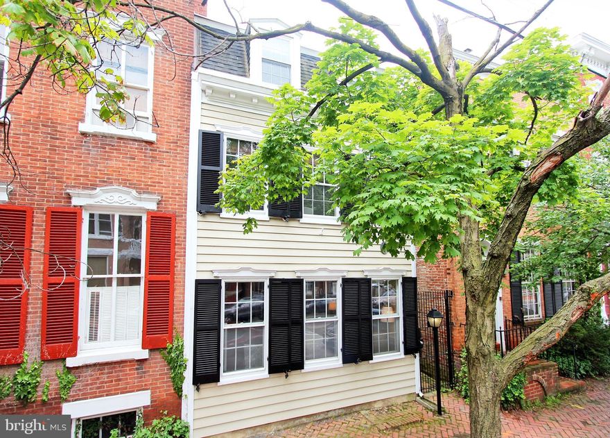 Historic, wood clapboard home just 1 block to King Street. Features include formal living & dining rooms, 2 fireplaces, large kitchen/family room with views of brick-walled garden, master bedroom with en-suite bathroom, and a sunny home office/den. Off street parking for two cars just beyond garden gate. Wonderful opportunity to own in a picturesque block. Home is brimming with potential!