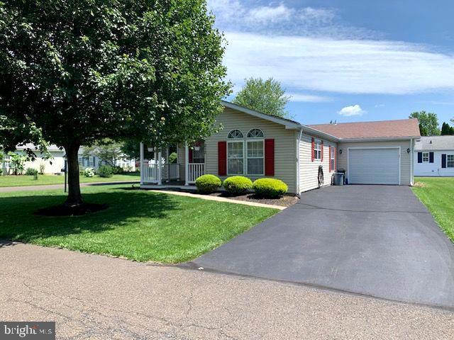 Such an immaculately well-maintained home on a beautiful maple tree-shaded lot corner lot! Great area of Buckingham Springs almost at the end of the street with very little traffic for quiet enjoyment. Sweet covered front porch with maintenance-free Trex Deck gives access to the front door as well sliding doors to the kitchen,,,So handy for picnic preparation! Spacious Living Room opens to the Dining room, so plenty of entertaining room, and adjoining the HUGE kitchen with amazing cabinet and countertop storage space. There is even a built-in desk/computer/cookbook counter and pantry! 2 generous bedrooms with amazing closet space! The main bath soaking tub was removed to add a HUGE closet or linens or whatever! There is a 1 car attached garage with a long driveway, enough room for 2-3 cars besides the garage space.
