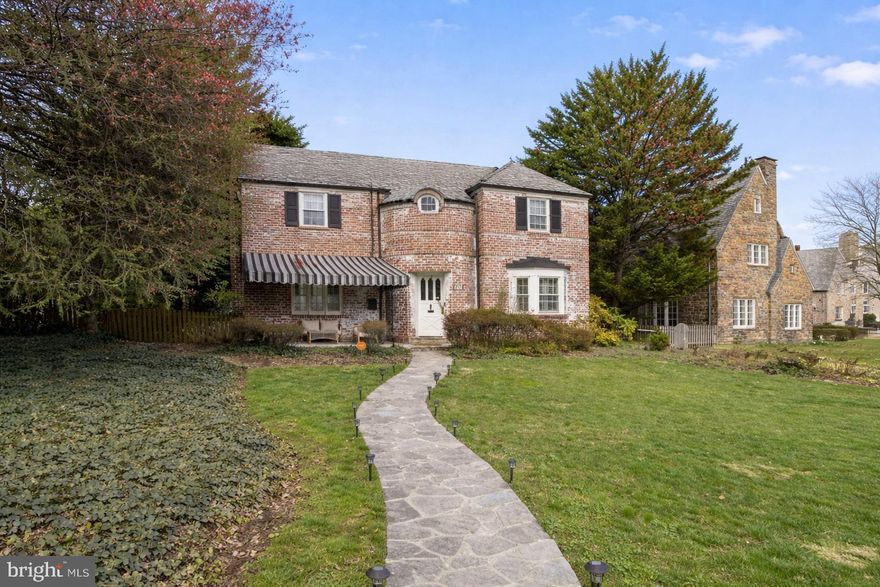 A rare offering in the heart of Homeland, this stately brick Colonial stands as a refined expression of timeless architecture and modern sophistication, just moments from the neighborhood’s iconic lakes. Set on one of the most coveted blocks, the residence commands presence while offering quiet, understated luxury.

Inside, the home unfolds with intention. Sunlight dances across gleaming hardwood floors, guiding you through a seamless layout designed for both grand entertaining and intimate daily living. At its center, a striking chef’s kitchen has been thoughtfully reimagined with custom cabinetry, granite surfaces, and an expansive island that anchors the space. It opens effortlessly into elegant living and dining areas, where a classic fireplace and curated finishes create a warm, elevated ambiance.

Upstairs, four beautifully proportioned bedrooms offer a private retreat, accompanied by renovated baths that blend comfort with refined design. The lower level introduces a new dimension of living—a flexible, finished space ready to become a media lounge, wellness studio, or creative escape.

Every detail has been considered, with key system updates including a newer HVAC system (2022), ensuring both comfort and peace of mind. Outside, a rare attached two-car garage and oversized driveway provide convenience. The landscaped grounds and covered front terrace offer a tranquil setting to unwind, complete with the gentle backdrop of Homeland’s signature fountains.

Beyond the property, Homeland itself remains one of Baltimore’s most storied enclaves, where winding roads, historic homes, and shimmering lakes create a setting of enduring elegance.

This is more than a home. It is a statement, a lifestyle, and a rare opportunity to own a piece of Baltimore’s architectural legacy.