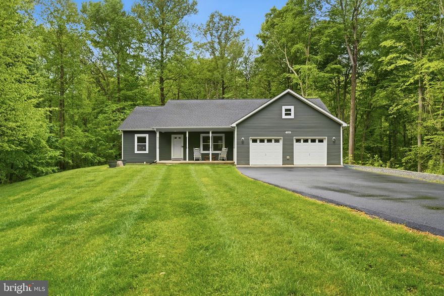 This charming rambler is perfectly situated on a picturesque 4.23-acre lot in the highly desirable Huntingtown location of Northern Calvert County.  Offering the ideal blend of privacy and convenience, this beautifully maintained property features a landscaped manicured yard complete with an irrigation system, a paved driveway with ample parking, and a spacious deck with sleek aluminum railings. Inside, you’ll find durable and stylish LVP flooring throughout, along with a functional, open layout designed for easy one-level living. The oversized 2-car garage provides plenty of storage space, while major updates, including a tankless water heater and a newer HVAC system installed in 2025, offer peace of mind for years to come. With thoughtful upgrades and room to enjoy the outdoors, this home truly has it all… and so much more!