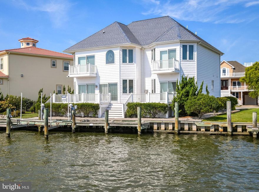 Luxurious direct waterfront living with breathtaking Bay Views. This 5BR/3.5 BA Waterfront Single family home is in Heron Harbour Isle. This beautiful home overlooks the Bay and comes with a deeded boat slip with lift, and vinyl bulkhead.  Share precious family time watching magnificent sunsets from the family room and enjoy the warmth of a fireplace for year around enjoyment.  The family room has a wet bar and is a perfect place to entertain family and friends. There is a glass slider and a wall of windows to optimize all the water views off both the family room and dining room. The large kitchen has granite countertops and plenty of cabinet space to delight the chef in your house.  There is an incredible waterfront deck for outdoor grilling and crab feasts.  The spacious waterfront master bedroom suite is on the first floor and has a master bath with shower and jacuzzi tub, walk in closets and a sliding glass door leading to a deck with incredible views overlooking the Bay.  As you go up the stairs you will immediately feel like you are in the Caribbean with all the bright colors and themed rooms. There is a second family area or office area with a balcony overlooking the water. The second floor also has a beautiful second bedroom overlooking the water with its own private balcony.  There is a Jack and Jill bath connecting the second and third bedrooms, and the fourth and fifth bedrooms also share a Jack and Jill bath.  One of the many highlights of this home is the awesome decks and balconies.  Use them to relax, listen to the water, watch sunsets night after night, and enjoy the boats as they go by. This home has many upgrades throughout, including 40 year shingles, heated tile floors, two car garage, finished bonus area over the garage,  2X6 construction on exterior walls, upgraded lighting, upgraded landscaping, and 2 zone heat with gas on the first floor, heat pump on the second. floor. Imagine yourself in this beautiful home  in one of the nicest communities in Ocean City.  Heron Harbour Isle is amenity rich with two outdoor pools, an indoor pool, a kiddie pool, fitness center, social room, sauna, locker room, two Har-Tru tennis courts, sidewalks and piers.  Enjoy your boat, fishing, crabbing, kayaking and paddle boarding all directly out your back door.