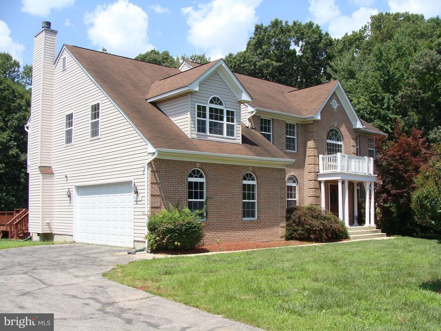 Secluded on 8 Acres of privacy. Beautiful brick front colonial accommodates a formal or family lifestyle. Owners suite with wonderful full bath and huge walk in closet plus an additional sitting room/TV area.
Family room with fireplace opens to backyard deck. Office and laundry on the first floor.  Full basement with finished full bath awaits your ideas and imagination or just keep the storage area.  Nature abounds and it's within an easy commute to Andrews AFB and all Washington DC has to offer.