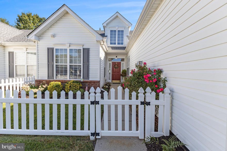 Welcome to your dream home in the highly sought-after 55+ community of Tarrington Village! This delightful 2-bedroom, 2-bathroom residence boasts charming curb appeal, complete with a white picket fence and a welcoming walkway leading to the front door. Step inside the foyer with hardwood floors and you'll immediately appreciate the spacious open floor plan. The eat-in kitchen is perfect for culinary enthusiasts, offering a built-in microwave, gas cooking, pantry, and plenty of cabinet and counter space. Adjacent to the kitchen is a formal dining room that flows seamlessly into the inviting living room, featuring crown molding, chair rail detailing, and access to a peaceful back patio. Here, you can relax and enjoy the outdoors, with convenient access to the community walking path. The primary bedroom suite is a serene retreat, featuring a walk-in closet, an additional linen closet, and an en-suite bath complete with double sinks and a walk-in shower. The second bedroom offers its own full bath across the hall, complete with a tile floor and a tub/shower combination. Convenient main-floor laundry with a utility sink adds to the ease of living, while the insulated walk-up attic space, featuring a double window, offers ample storage or the potential to create an additional living area, home office, or hobby room. This home also includes a one-car attached garage and is ideally located close to shopping, dining, and major roadways, making it both convenient and comfortable. Don’t miss your chance to make this charming home yours!