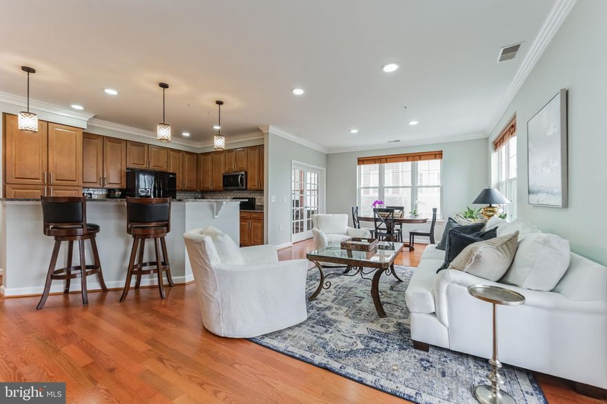 Light-filled & spacious! Rare opportunity for luxury living at Patapsco Overlooks 55+ community. This condo features gorgeous hardwood floors throughout, granite countertops, crown molding, recessed lighting and so much more! Lovely covered balcony complete with a ceiling fan rough-in. The spacious primary suite features a large walk-in closet and en suite bathroom complete with dual granite vanities, ceramic tile, a tub and separate shower with a glass enclosure. A vibrant community with great amenities including a clubhouse with an exercise room, a meeting/conference room, and plenty of space for entertaining and socializing. A basic cable package with Verizon Fios is included in the condo fee which provides for 1 cable box, and high-speed wifi, and offers a discounted rate on any upgraded services they want to purchase - an approximately $200 value. Also included is one deeded, covered parking space (#11) in the garage under the building and a storage locker (#8).  Your private balcony faces due west for nightly sunsets. Conveniently located just minutes away from Catonsville Village activities, shops & restaurants. Explore nearby historic Ellicott City and Patapsco State Park trails. There's so much to love about this condo & location... Schedule your showing today!