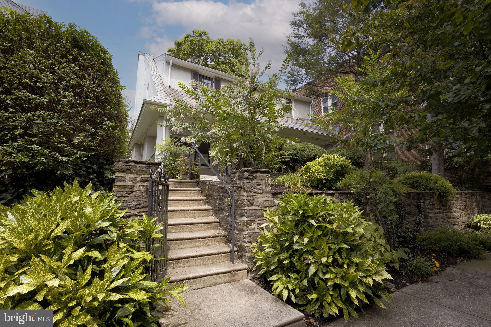 Rare opportunity to own a single, detached home with a four car garage and huge front porch in ever desirable West Mount Airy! Located on a quiet, tree-lined street the charm of the home is apparent from the moment you walk up and see the large and inviting covered front porch. Upon entering there is a lovely living room with a working fireplace, coat closet and windows on three walls. This level also features a separate, spacious dining room. Beyond the dining room is the kitchen with wood cabinets, plenty of storage and a double sink. There are four bedrooms on the second floor, including one that has an en suite powder room. There is a full hall bathroom on this level as well. Both the front and back yards are spacious and ripe for gardening. The cherry on top? A detached garage that can fit four cars! It has one double garage and two singles and the possibilities are endless. This home has it all- loads of original detail and character, hardwood floors throughout, excellent entertaining spaces and a prime location. Coffee shops, public transportation, restaurants, hiking trails and more are all right outside your door. This one is a gem!