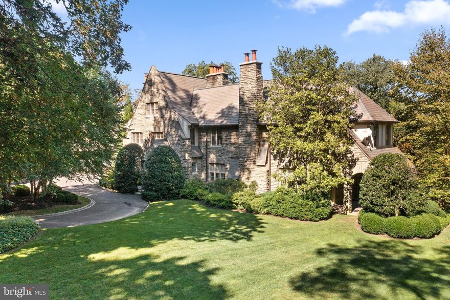 This grand Main Line estate home is a haven of quiet, tranquility, and unmatched privacy. The solidity of a classic stone home meets the allure of updated interior finishes, crafting a masterpiece where classic Main Line charm and modern amenities merge in harmony. This union results in an offering that seamlessly caters to today's discerning buyer — truly the best of both worlds.
 
From the grand two-story foyer, warmed by a wood-burning fireplace, to the gourmet kitchen, every space within is a testament to meticulous design and premium finishes. Expansive windows bathe each room in natural light, while multiple doors foster a fluid bond with the vast outdoors.
 
The second floor offers five generously proportioned bedrooms, offering luxury at every turn: en-suite bathrooms, radiant floor heating, walk-in closets, and custom built-ins. The third level boasts additional rooms, including one currently serving as a gym, enhanced by features like a cedar closet.  
 
The daylit lower level adds to the home's living space, connecting to the rear grounds via a walk-up staircase.
 
Outside, the grounds shine with meticulous landscaping: statuesque mature trees, meticulously crafted stone walls, flagstone terraces, and curated plantings. The pool house is an architectural marvel, showcasing a fusion of wood and metal in its design. Amenities like the pool, hot tub, full bathroom, shaded terrace, and outdoor kitchen solidify its standing as a luxury leisure retreat. 
 
Rounding off this Main Line jewel is a 3-car garage. 
 
This prestigious residence enjoys proximity to award-winning schools, shopping, dining, and recreation, accentuating its allure for those seeking a harmonious blend of luxury and convenience.