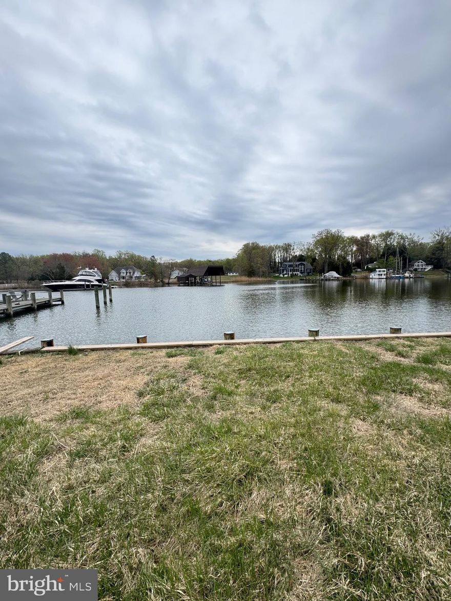One of a kind  flat waterfront lot boasting 157 feet of bulkhead with a private pier and boat lift and deep water, this stunning property offers the epitome of coastal living. On Whitmarsh Creek just off the Rhode River. The sellers bought the property and were issued an approved AA County grading permit to tear down the original house. The house has been torn down and the sellers are about 2 weeks away from having an approved building permit for a 6500 sqft brand new house! The sellers may be moving out of state so they decided it might be time to pass this dream on to a new owner. The price listed is for the land only.