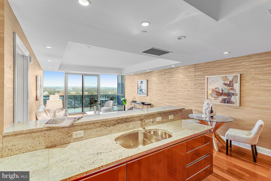 Luxe one-bedroom, two-bath condo at Turnberry Tower with floor to ceiling windows, offering plenty of natural light and incredible views of the Potomac River from the 17th Floor. 1,400 sq ft of living space, with Brazilian Cherry hardwood floors throughout, and an expansive 32’ balcony with western-facing views for catching sunsets and treescapes that change with the seasons. The large den is a perfect spot for a home office, easily transformed into a guest bedroom - featuring a Murphy bed with storage! The well-appointed kitchen features Snaidero Italian cabinetry, gas cooktop with Miele exhaust fan, Miele wall oven and Sub Zero refrigerator. The primary bedroom has direct access to the balcony through sliding glass doors. The primary bath features marble flooring and surround, double vanities, a large glass framed walk-in shower, and a 6 ft soaking tub. A second full bath, with a glass framed walk-in shower, is super convenient for guests. This condo unit has a new heat pump, conveniently located in the hallway, just outside the unit, as well as a storage unit on level P3 ($15K value). Turnberry Tower features a variety of luxury amenities including 24/7 valet service for owners and their guests vehicles, full time concierge service, a fully equipped fitness center, an indoor heated pool, theater room, a social club and business center.