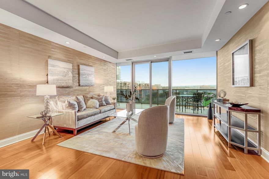 Luxe one bedroom, two bath condo at Turnberry Tower with floor to ceiling windows, offering plenty of natural light and incredible views of the Potomac River from the 17th Floor. 1,400 sq ft of living space, with Brazilian Cherry hardwood floors throughout, and an expansive 32’ balcony with western-facing views for catching sunsets and treescapes that change with the seasons. The large den is a perfect spot for a home office, easily transformed into a guest bedroom - featuring a Murphy bed with storage! The well-appointed kitchen features Snaidero Italian cabinetry, gas cooktop with Miele exhaust fan, Miele wall oven and Sub Zero refrigerator. The primary bedroom has direct access to the balcony through sliding glass doors. The primary bath features marble flooring and surround, double vanities, a large glass framed walk-in shower, and a 6 ft soaking tub. A second full bath, with a glass framed walk-in shower, is super convenient for guests. This condo unit has a new heat pump, conveniently located outside the unit, in the hallway, as well as a storage unit on level P3 ($15K value). Turnberry Tower features a variety of luxury amenities including 24/7 valet service for owners and their guests vehicles, full time concierge service, a fully equipped fitness center, an indoor heated pool, theater room, a social club and business center.