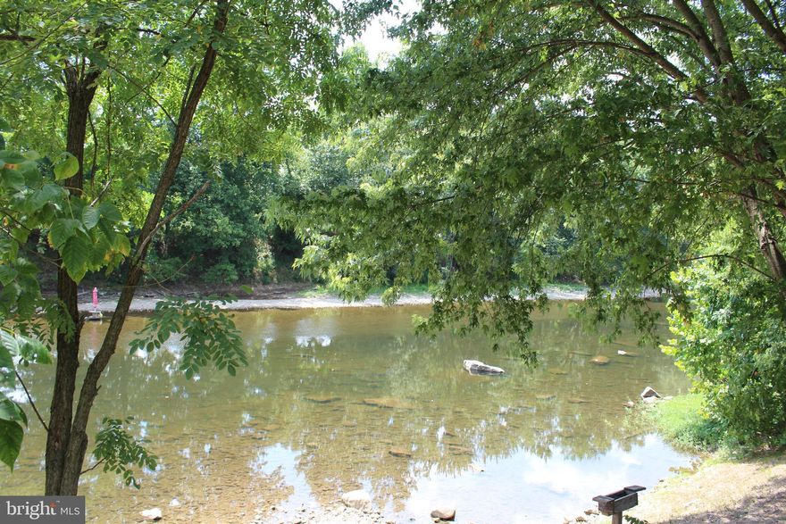 River Front! Beautiful 3.38 acre level lot fronting the South Branch Potomac River.  All useable land and easy walk in river access.  Get away, relax and enjoy the pleasures of swimming, canoeing, kayaking, fishing  while taking in the picturesque mountain views all around you.  The lot features a well(with one year old well pump),  electric service, pavilion, and a 2006 trailer that sleeps five, as well as a few outbuildings and a storage trailer.  The Cub Cadet riding mower, picnic table and a grill and refrigerator under the pavilion also convey.