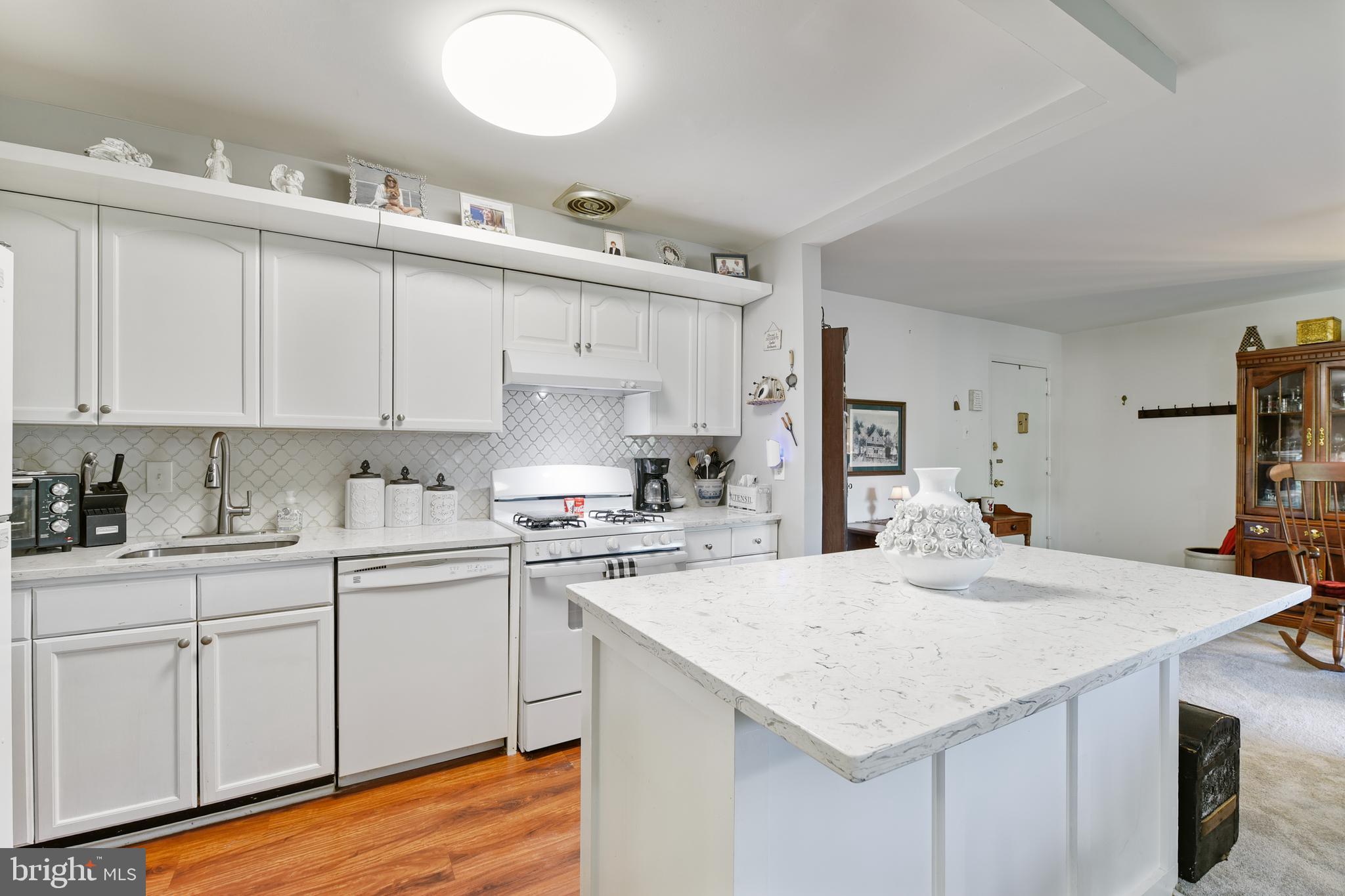 Enjoy everything Annapolis from this cozy Fairwinds condo. Second Floor unit, two bedroom, two full bath. Updated kitchen in 2023 with luxury vinyl plank flooring, beautiful cabinets, granite countertops and an oversized island with extra storage. New Stove in 2025. New HVAC compressor in 2025. Primary bath updated in 2023. The primary bedroom is large featuring a built-in vanity and double closets with built-in shelves. Second full bathroom features a full-size walk-in shower. Generously sized second bedroom. Laundry in unit. Welcoming balcony. Condo fee includes gas heat, cooking, and hot water.