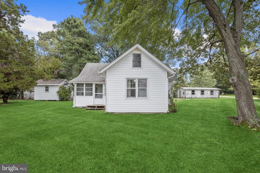 Wonderful opportunity for quaint and quiet living in water privileged Shady Side. This idyllic property is one generously sized lot at 0.72 acres with multiple outbuildings including a 40x14 shed with electric, a storage shed with both electric and heat, a detached garage, and ample space for your RV or boat. Nestled adjacent to the public boat launch and kayak launch you are just steps from the water. On warm sunny days, take a stroll to the water with your family or pets. Shade trees, mature grape vines, and garden space are both beautiful and functional.  This charming cottage has undergone recent updates including interior paint, a kitchen renovation with granite counters, tile backsplash and windows, a new roof, and new vinyl siding. The interior is graced by a kitchen and dining combination, a spacious living room with cozy gas stove, two sizable bedrooms, a full bath, a walk-up attic, and enclosed porch.  With ample room for expansion, this home is just waiting for your inspired design touches and modern ideas! Multiple restaurants, an ice cream shop, a local grocery store and elementary school are mere minutes away. Multiple Marinas are nearby as well as Jack Creek Park for outdoor recreation, sandy beach, and bird watching over the Chesapeake Bay. While this picturesque setting will feel like a retreat, you are still within commuting distance to Annapolis and DC. Look no further for tranquil southern Anne Arundel county living!