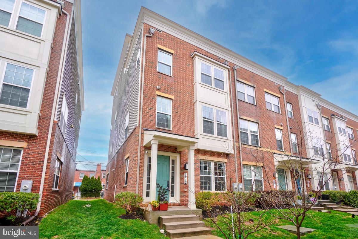 This Hampden gem end-of-group, 4-bedroom, 4-bathroom townhome is spacious and inviting, with three light-filled exposures and thoughtful, high-end amenities. The home is ideally located - just one block from Hampden's "The Avenue," readily accessible to I-83 (and light rail), and steps from some of Baltimore's best restaurants and burgeoning craft brewery scene. Enjoy the expansive green space of nearby Roosevelt Park or stroll through the trails of Druid Hill Park, a short walk away. Enter the home from the private courtyard of Hampden Square to soaring ceilings and large double doors that invite you into the versatile first-floor bedroom/office. Access the dedicated full bath and attached two-car garage on this entry-level. Head upstairs to the airy, open, and light-filled main floor with a spacious living room featuring an integrated gas fireplace and custom built-ins. Adjacent is a balcony deck that is accessible for grilling. The living area flows into the large gourmet kitchen, outfitted with stainless steel appliances, a gas stove, and a comfortable island with ample seating. Continue into the expansive dining area to complete this perfect-for-entertaining space. Head upstairs to where two bright and spacious bedrooms await, both featuring ensuite baths and custom walk-in closets for ultimate ease of living. Enjoy the convenience of a centrally located laundry room. Pass the hand-painted frame mural wall as you approach the top floor, where you will find an additional bedroom with a full bath as well as an entertaining space with a wet bar and wine refrigerator that opens onto a roof-top deck that is uniquely equipped to enjoy all seasons. The double-sided fireplace keeps the space cozy through winter, while the automatic retractable awning covers the deck with cooling shade through summer. Enjoy views across the Jones Falls to the old growth forest of Druid Hill Park and beyond. Book a showing today to experience this standout home, combining convenience, luxury, and practicality all under one roof.